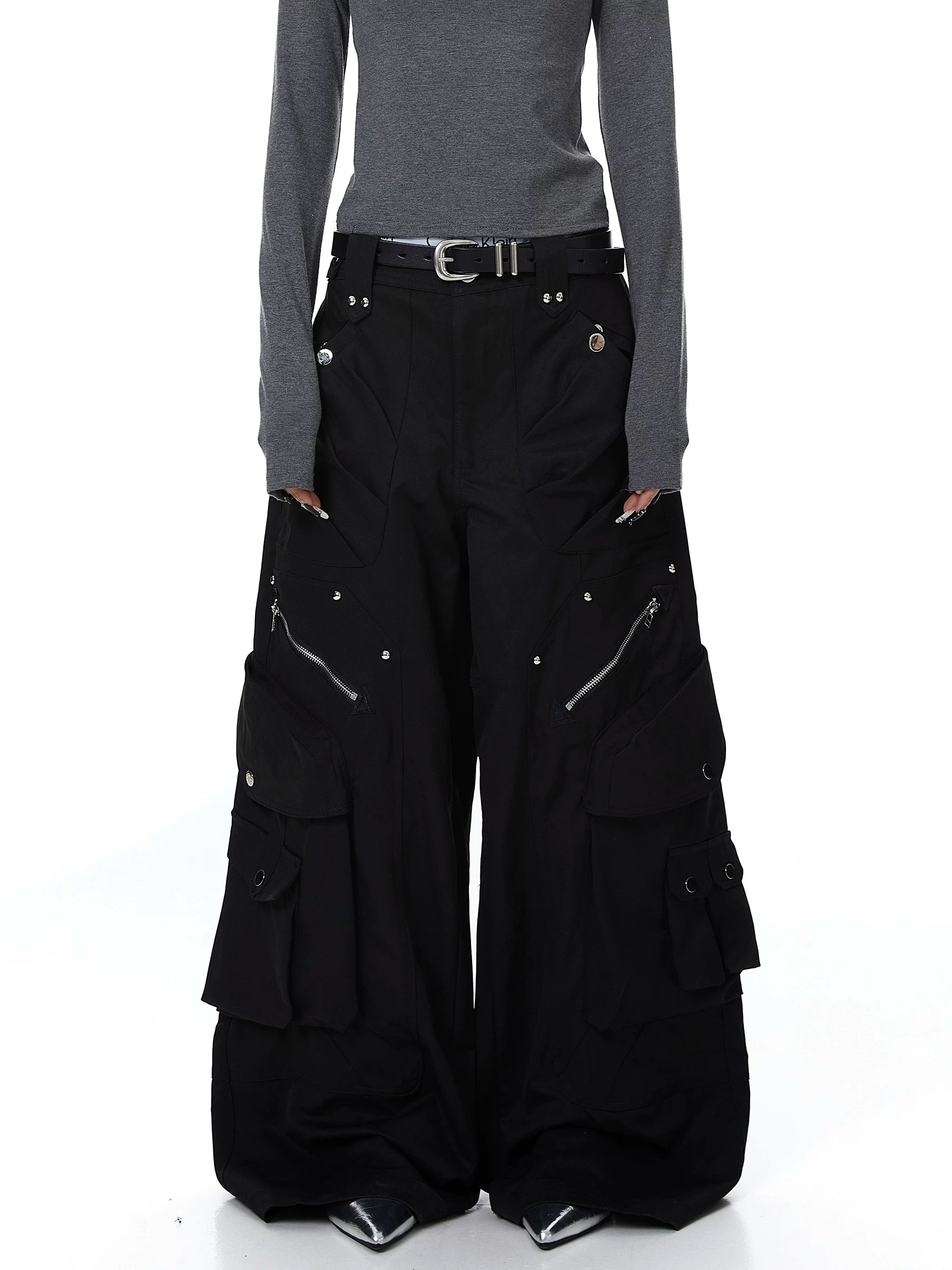 Sanhoostudio cargo pants featuring heavy utility construction, stud details, and multi-pocket design. Built with a wide leg silhouette for bold streetwear outfits.