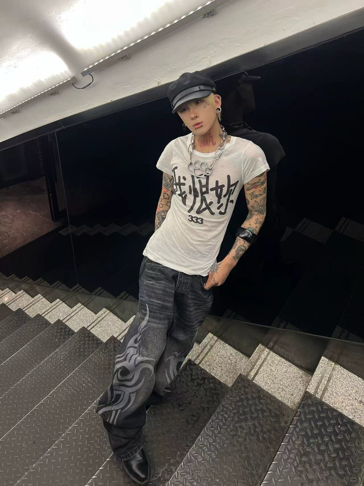 These Sanhoostudio jeans showcase bold totem rune prints across a wide-leg straight cut. The oversized fit and retro wash add cultural inspiration to streetwear, making them a unique fashion-forward piece.