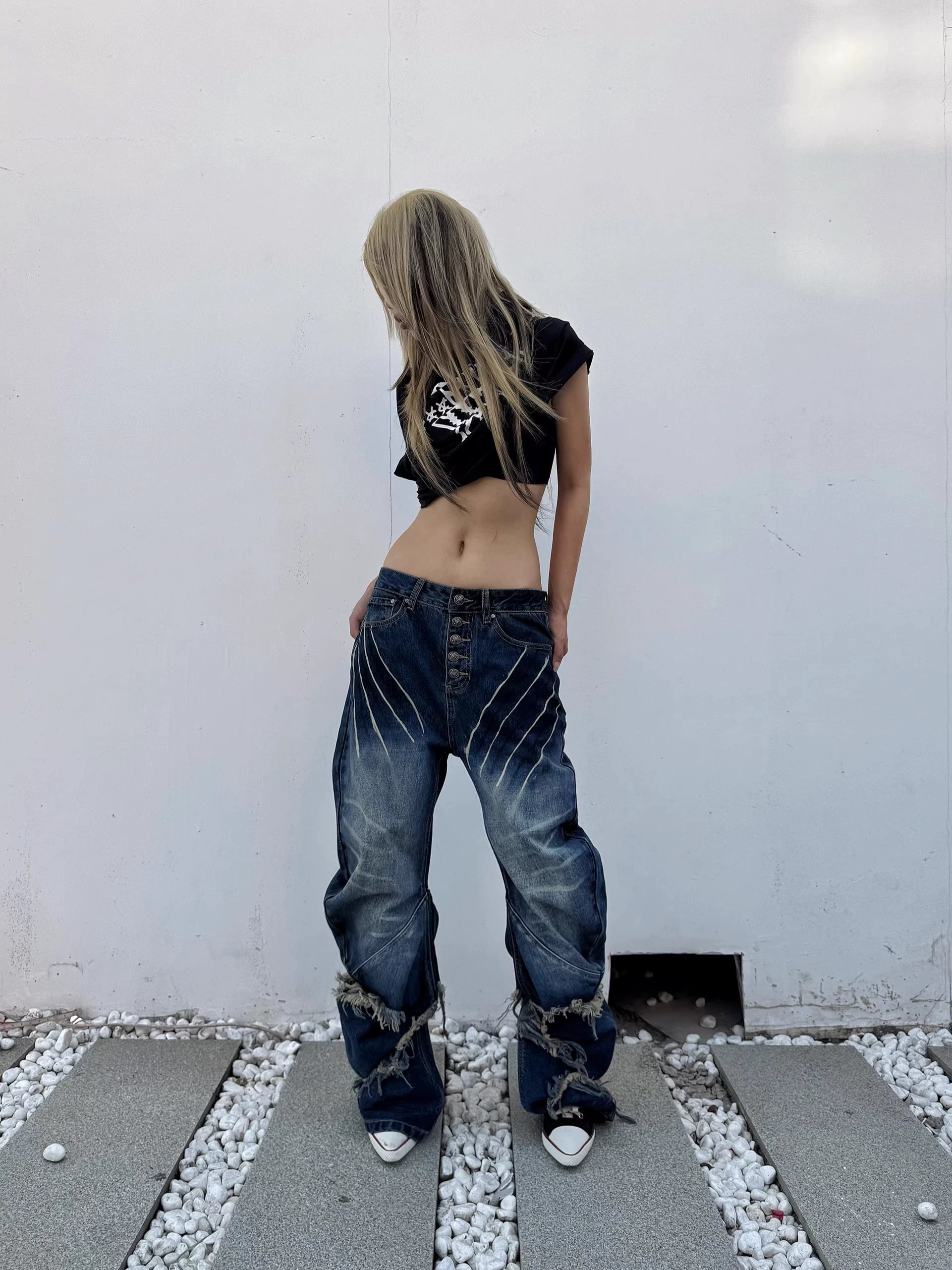 Sanhoostudio’s distressed claw-scratch denim scimitar pants feature washed patchwork craftsmanship, a loose fit, and slight stretch for comfort. Designed in blue-black denim, they bring an edgy streetwear vibe to any casual or punk-inspired outfit.