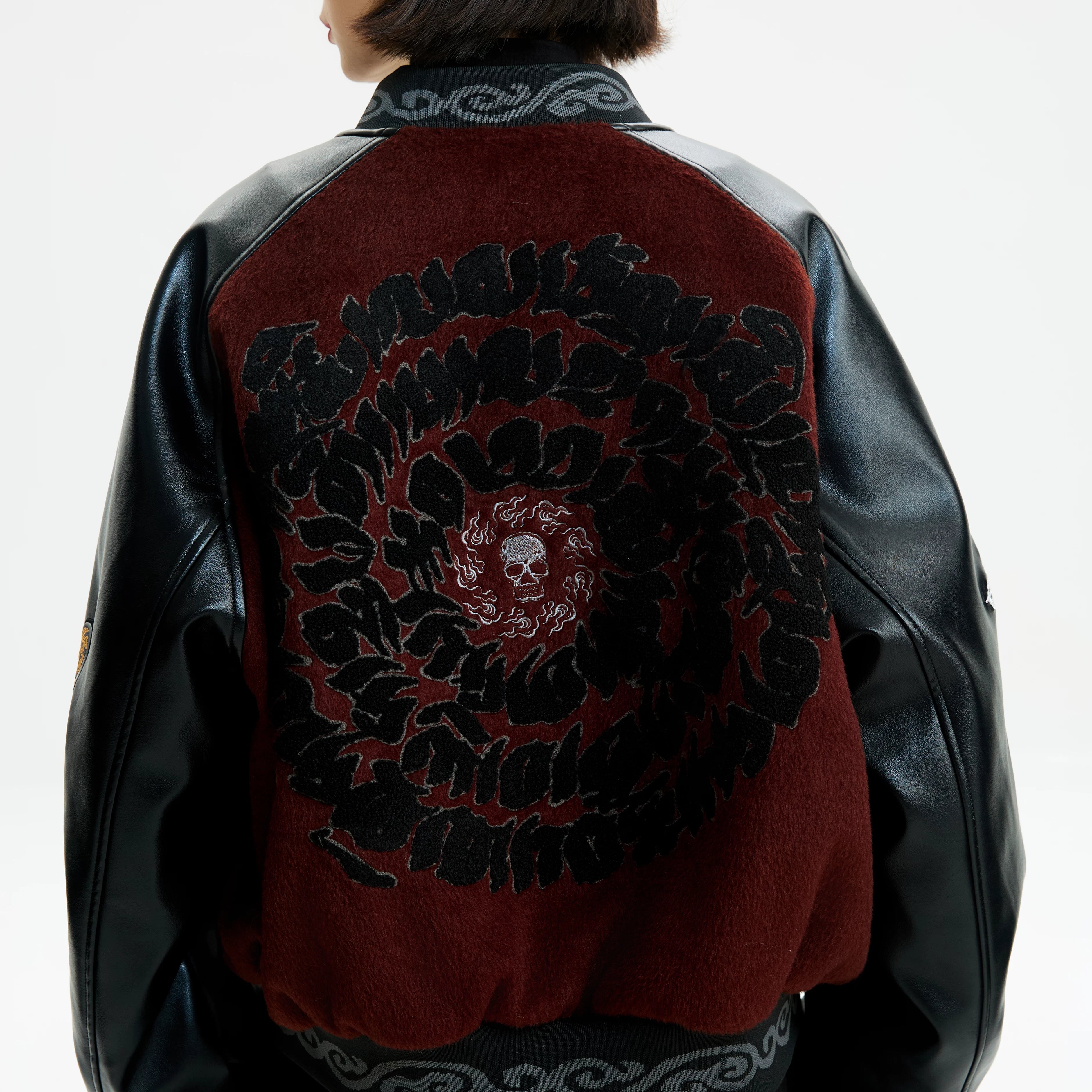 Sanhoostudio padded varsity jacket featuring vintage embroidery and relaxed fit. A unisex winter outerwear essential.