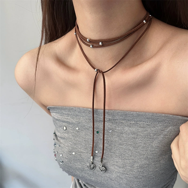 Express effortless Bohemian charm with Sanhoostudio’s silver heart wrap necklace. The long leather cord design combines vintage texture with modern simplicity.