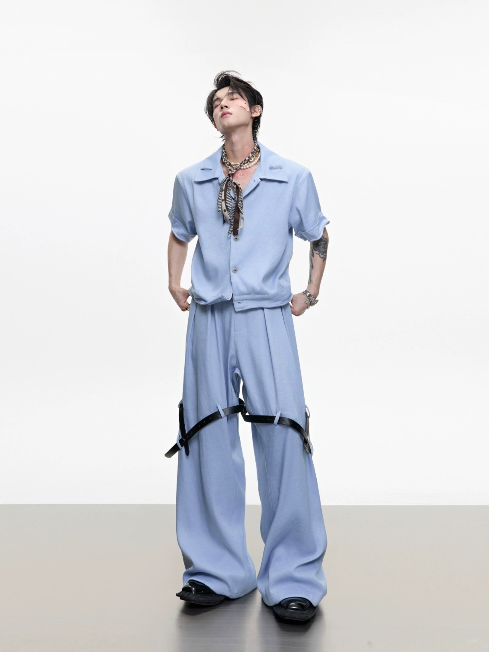 The Sanhoostudio twill textured pants showcase structured tailoring with unique belt-inspired patchwork. Combining minimalism with avant-garde detailing, they bring an elevated urban aesthetic to both casual and semi-formal styling.