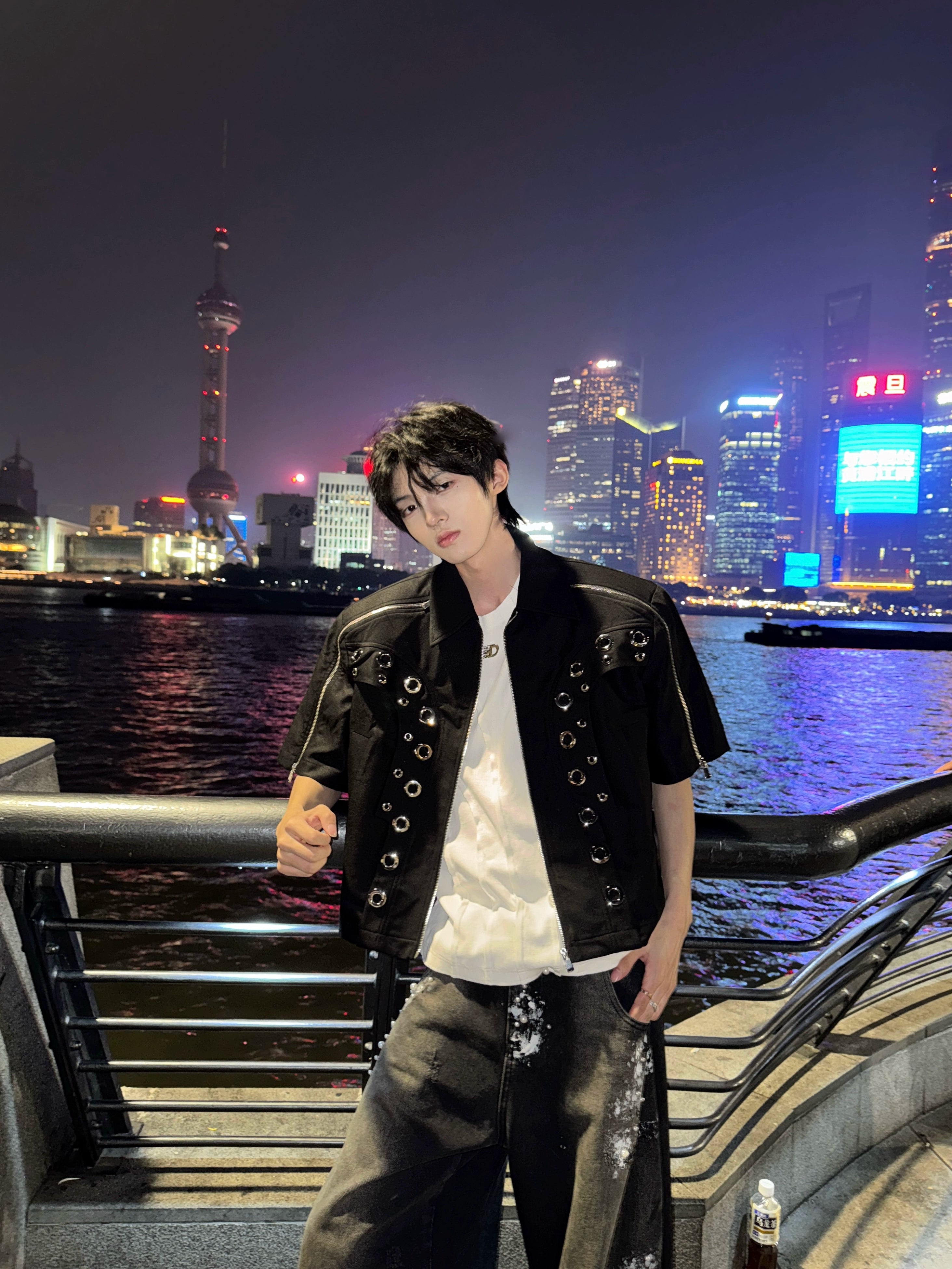 This avant-garde cropped jacket by Sanhoostudio showcases futuristic hollow-metal inspired cutouts with bold shoulder pads. Its oversized silhouette, lightweight material, and modern edge make it a standout layering piece for streetwear fans who embrace unique design and cutting-edge style.