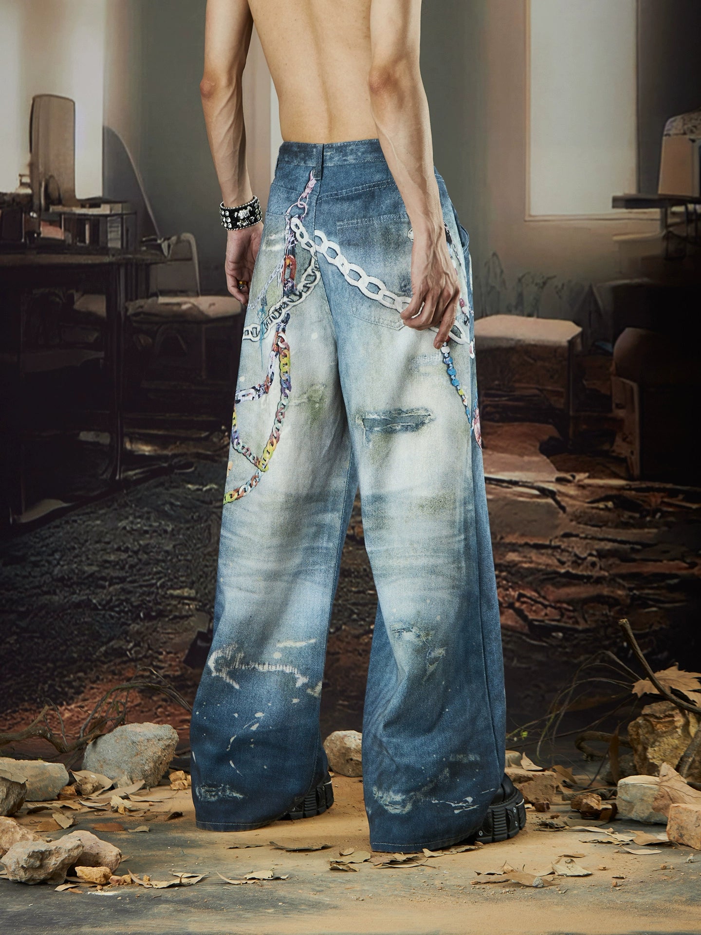 The Sanhoostudio jeans combine digital multicolor chain prints with a washed distressed finish in a straight-leg silhouette. Their oversized cut and bold pattern make them an expressive statement piece for modern streetwear outfits.