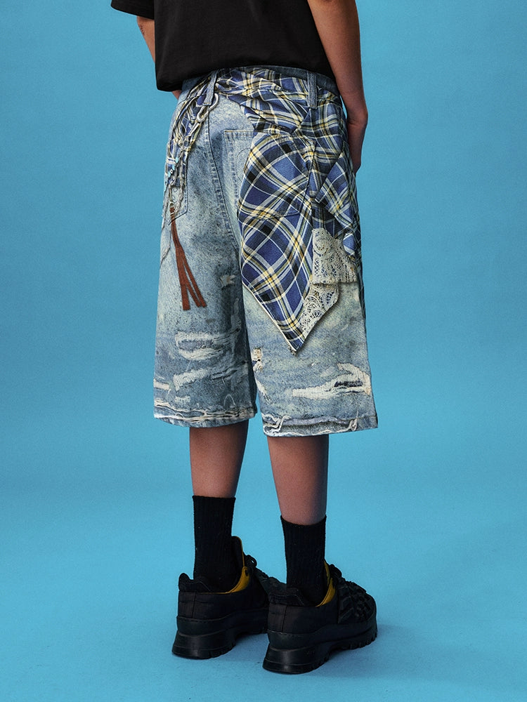 These Sanhoostudio denim shorts feature plaid-inspired patterns with chain print accents, merging casual denim with bold graphic expression. With a relaxed oversized fit, they’re ideal for layering into creative high street looks.