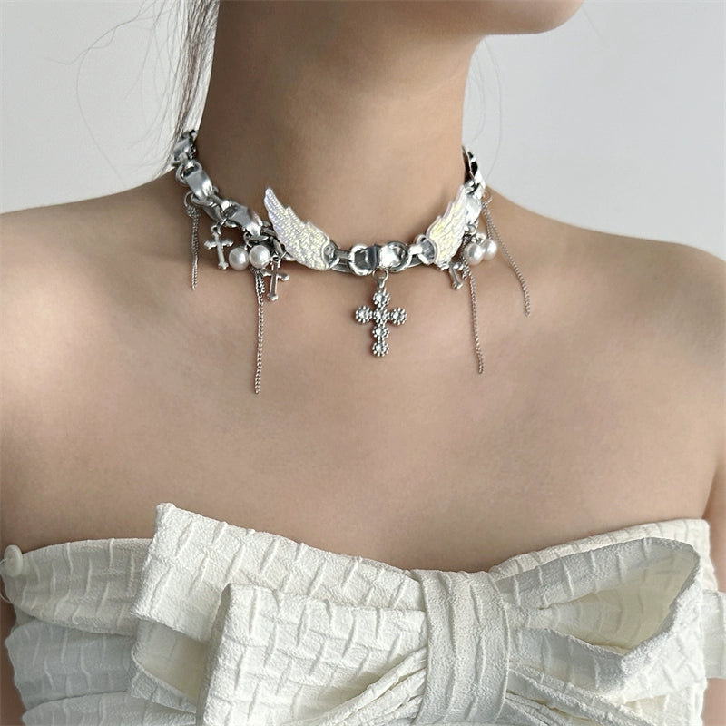 Sanhoostudio’s Y2K-inspired wing cross choker captures futuristic rebellion and feminine strength. A perfect balance between bold design and refined glamour.