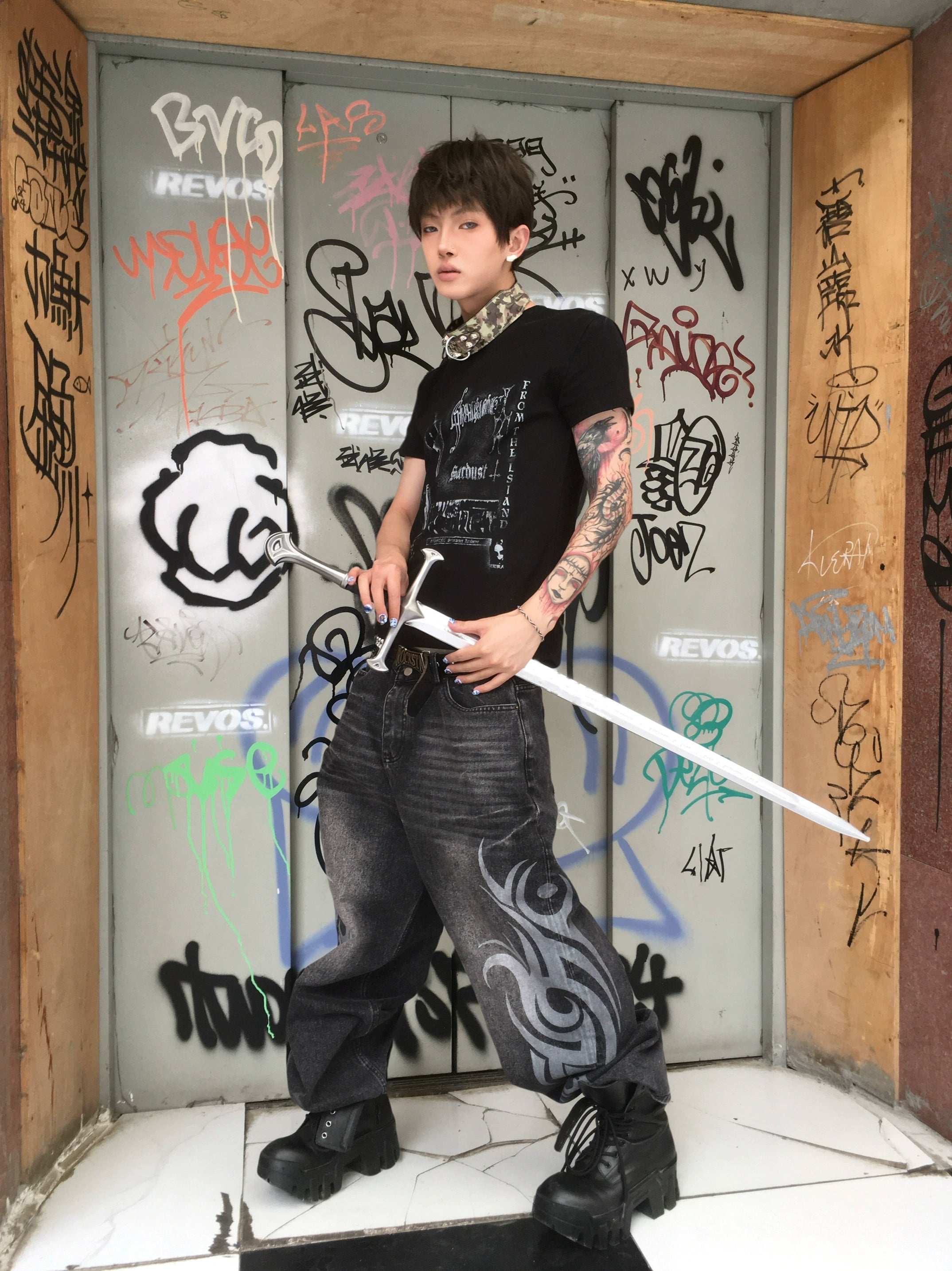 These Sanhoostudio jeans showcase bold totem rune prints across a wide-leg straight cut. The oversized fit and retro wash add cultural inspiration to streetwear, making them a unique fashion-forward piece.