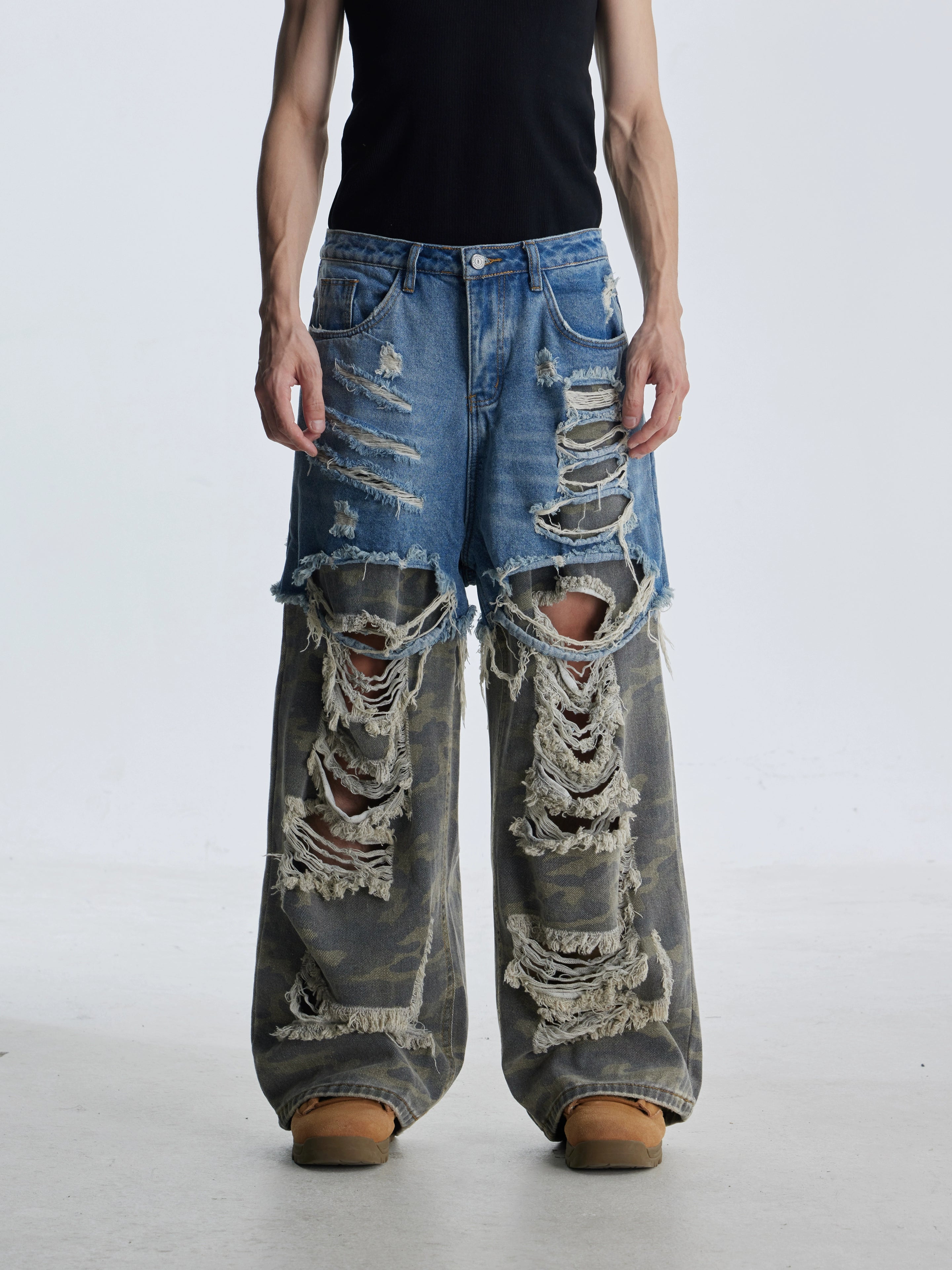 These deconstructed patchwork camo jeans from Sanhoostudio feature a unique layered fake two-piece effect, distressed ripped accents, and a loose straight-leg silhouette. Combining vintage inspiration with edgy high street aesthetics, they are perfect for streetwear lovers seeking comfort, individuality.