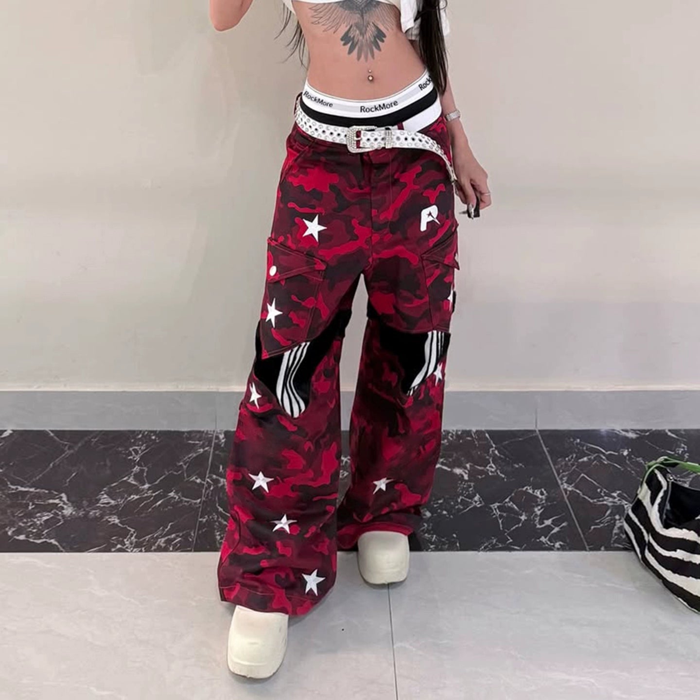 These Sanhoostudio camouflage pants feature bold star prints, patchwork design, and a low-waist loose fit. With their retro streetwear inspiration, they merge military ruggedness with casual style, making them a versatile staple for high street fashion.