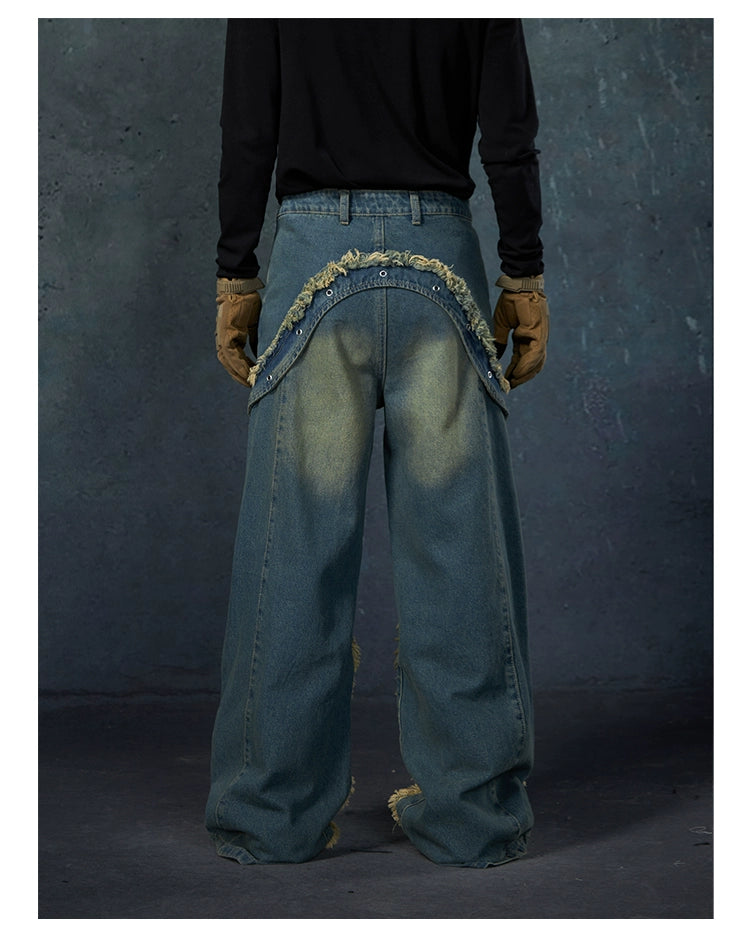 These Sanhoostudio jeans feature heavy deconstruction with strap patchwork, raw edges, and a vintage washed finish. Their oversized straight-leg silhouette adds a rugged, rebellious feel, blending avant-garde design with high street attitude.