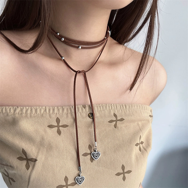 Express effortless Bohemian charm with Sanhoostudio’s silver heart wrap necklace. The long leather cord design combines vintage texture with modern simplicity.