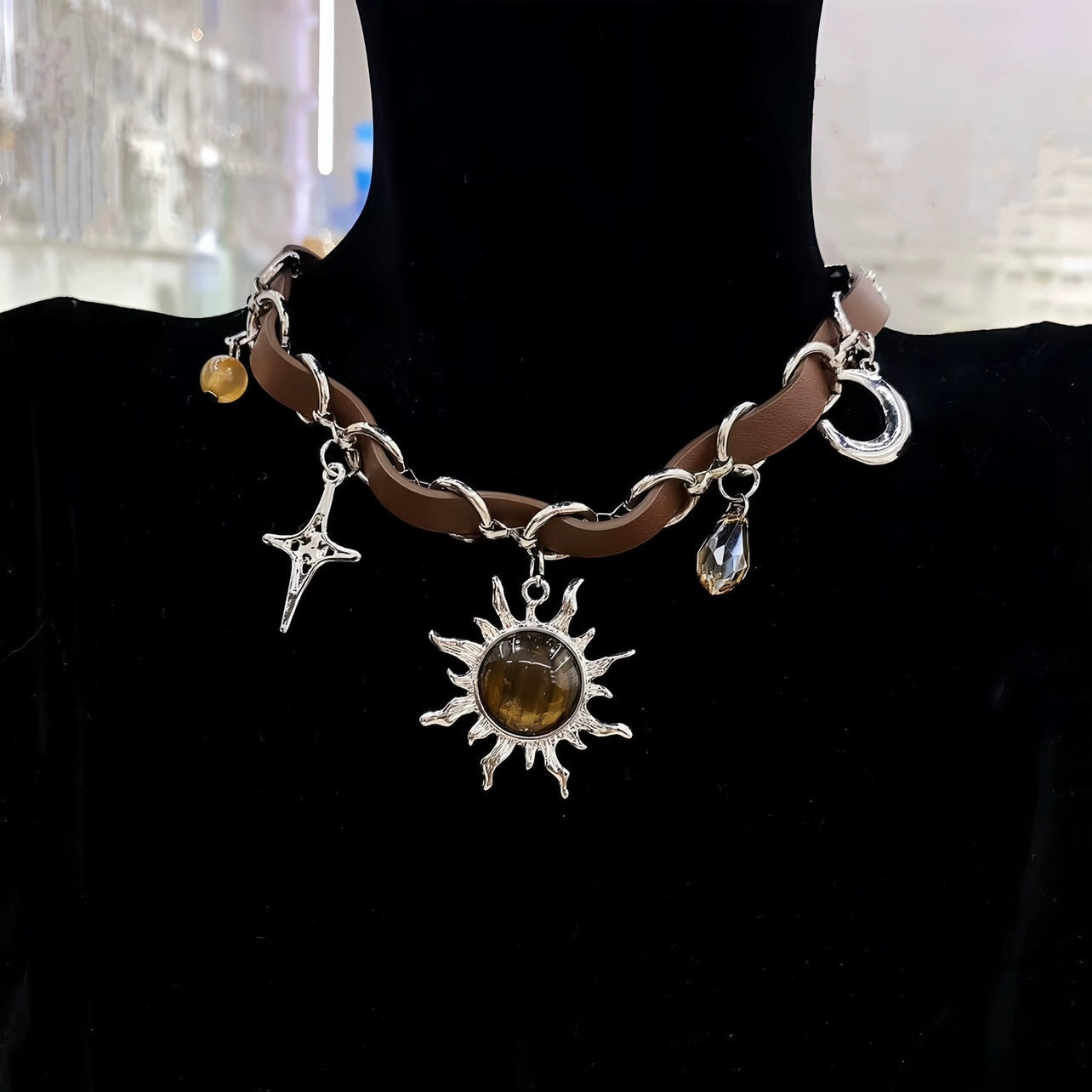 Sanhoostudio’s Mallard brown sunburst choker necklace showcases a bold sun-inspired design with warm brown tones, perfect for fashion-forward individuals seeking a standout, retro-luxe accessory.