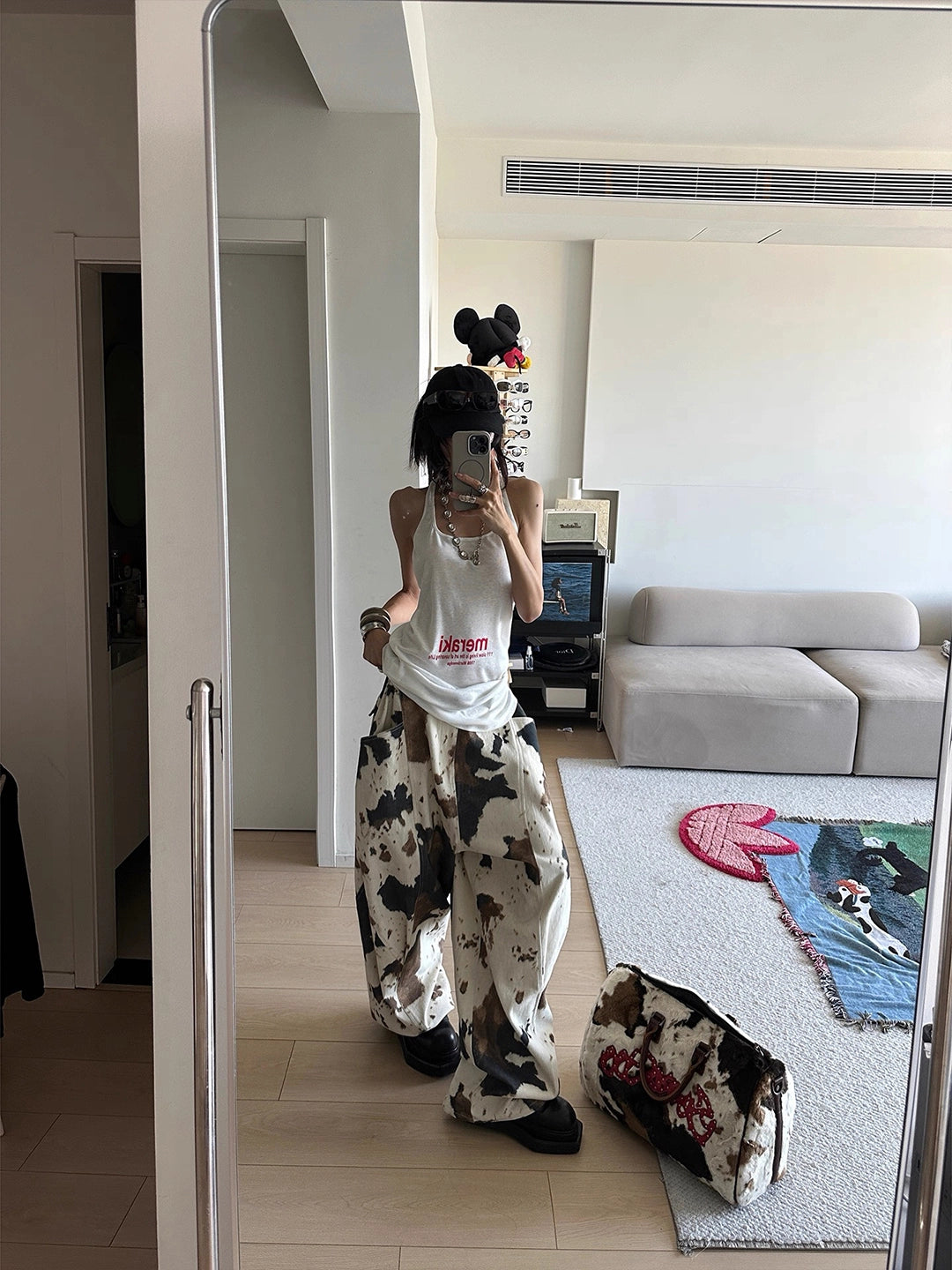 The Sanhoostudio cow print jeans feature a soft apricot colorway with wide-leg design and vintage wash. Playful yet versatile, they fuse retro charm with modern high street fashion.