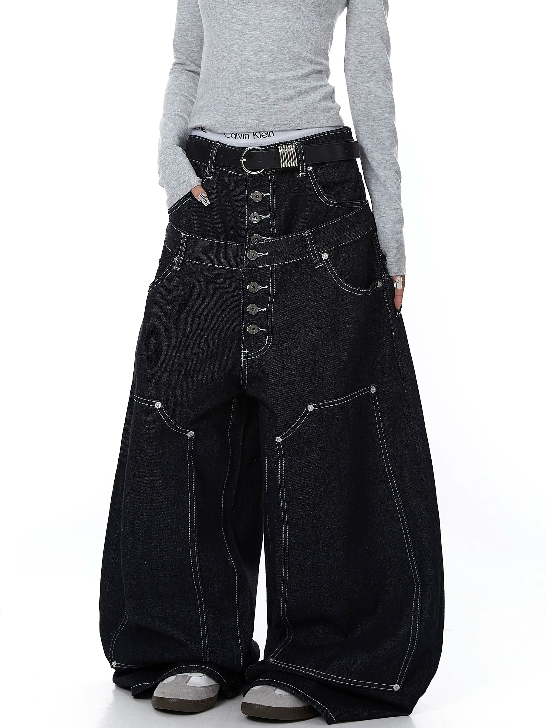 Sanhoostudio denim pants featuring double waistband design, exposed stitching, and button details. Built with a wide leg silhouette for high street styling.