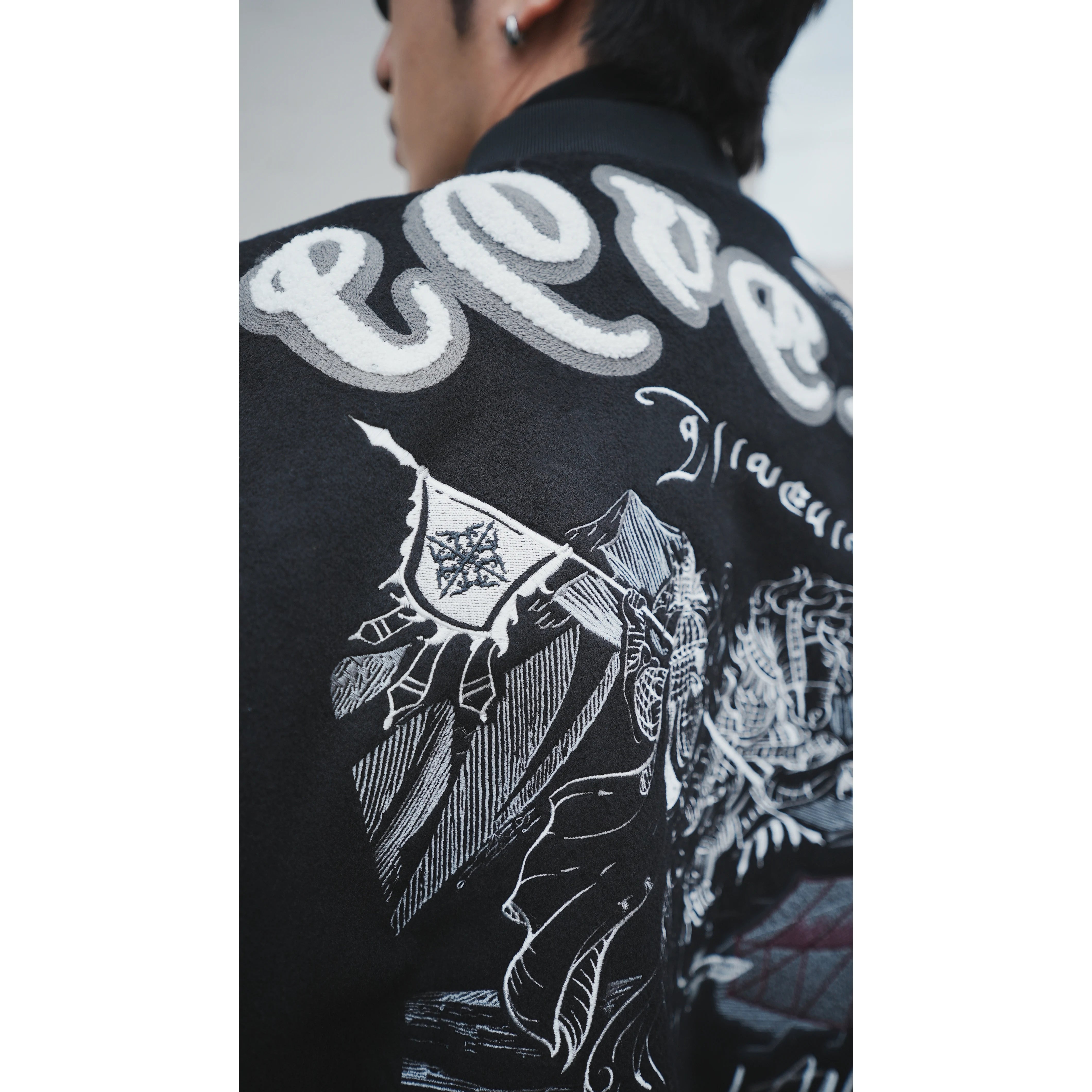 Sanhoostudio heavyweight varsity jacket featuring embroidery and wool blend fabric. Designed for bold unisex streetwear.