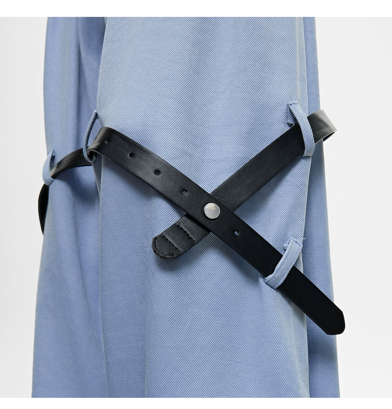The Sanhoostudio twill textured pants showcase structured tailoring with unique belt-inspired patchwork. Combining minimalism with avant-garde detailing, they bring an elevated urban aesthetic to both casual and semi-formal styling.