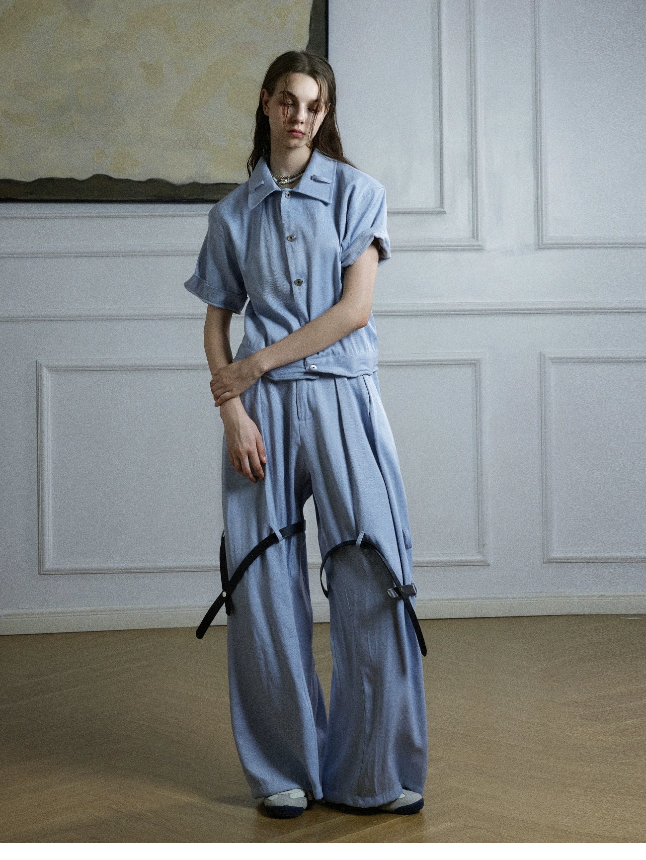 The Sanhoostudio twill textured pants showcase structured tailoring with unique belt-inspired patchwork. Combining minimalism with avant-garde detailing, they bring an elevated urban aesthetic to both casual and semi-formal styling.