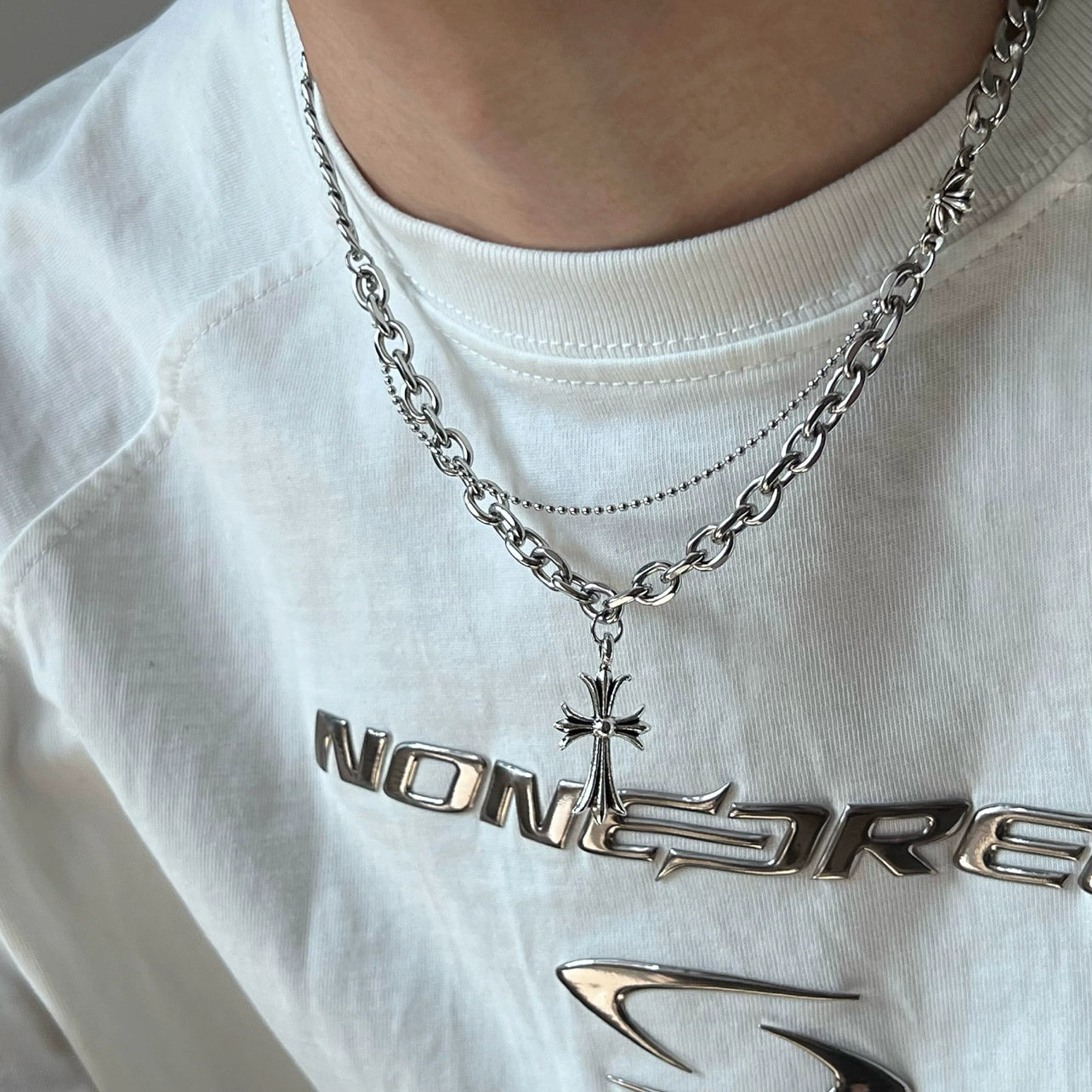 Discover Sanhoostudio’s cross double-layer titanium necklace—sturdy titanium construction paired with layered chains for a versatile unisex accessory suitable for casual and dressy street looks.