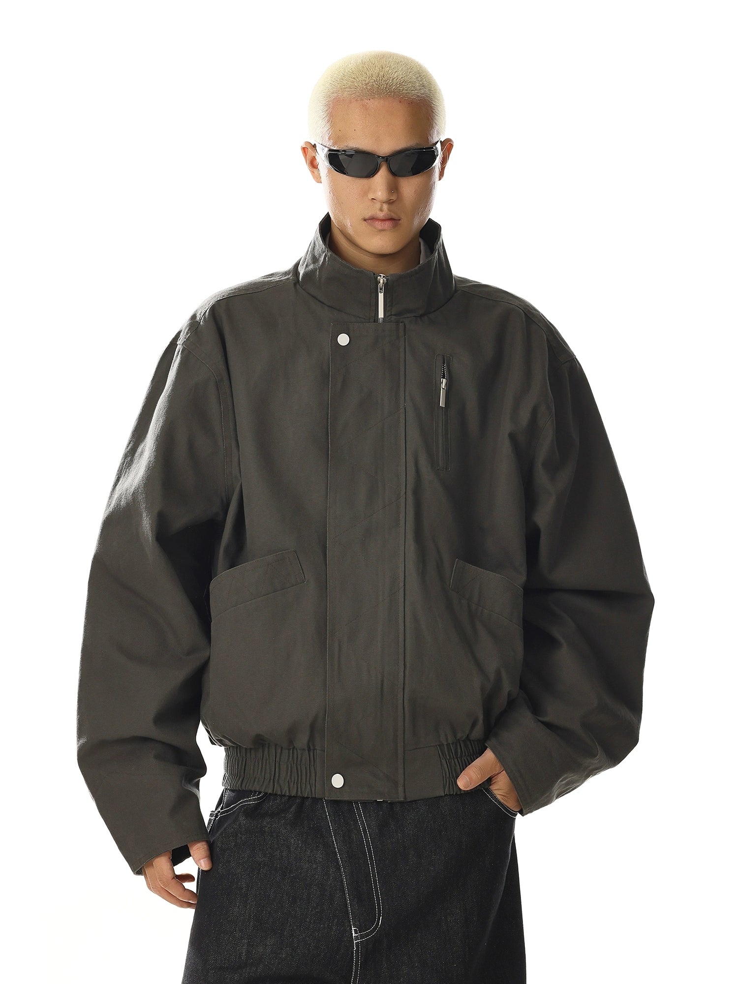 Crafted for versatility, this retro-inspired flight jacket features a stand collar and utility pocket design. Its cleanfit tailoring and oversized comfort make it a staple for streetwear enthusiasts. Shop unique outerwear at Sanhoostudio.