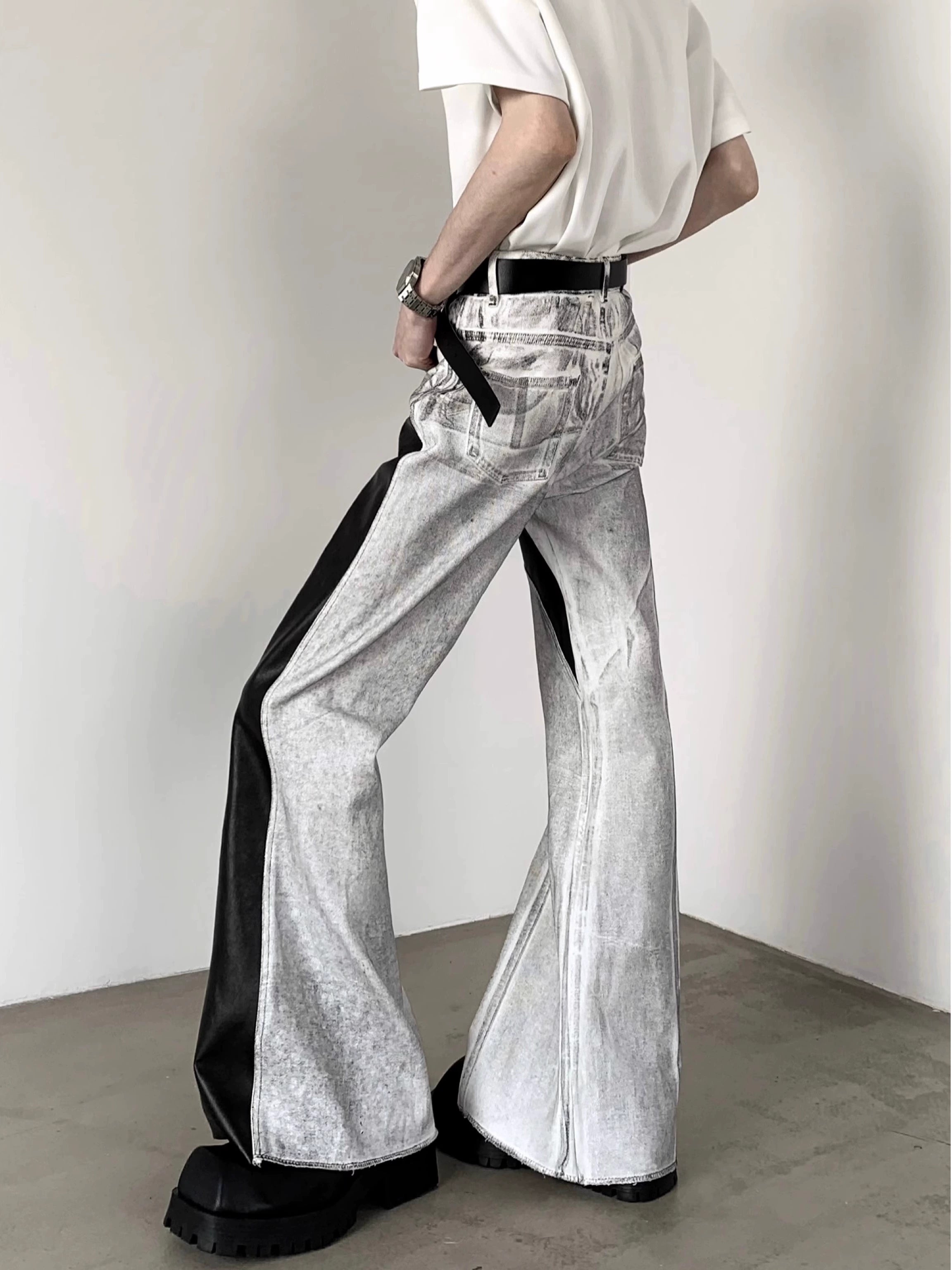 The Sanhoostudio distressed off-white jeans combine premium leather patchwork with a subtle flared cut. Their faded finish adds a rugged vintage vibe, while the unique detailing enhances versatility, making them a must-have for bold, high-fashion urban wardrobes.