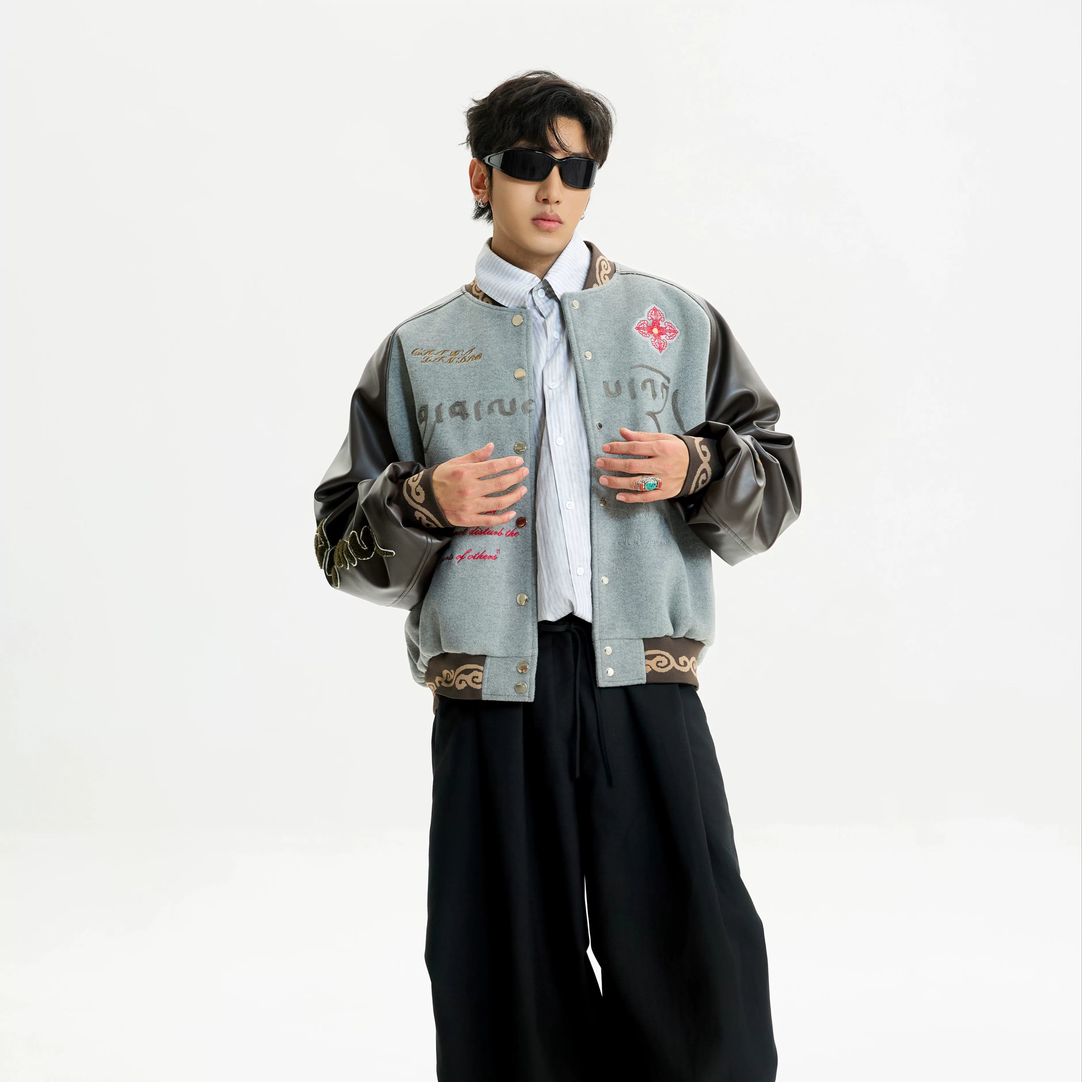 Sanhoostudio padded varsity jacket featuring vintage embroidery and relaxed fit. A unisex winter outerwear essential.