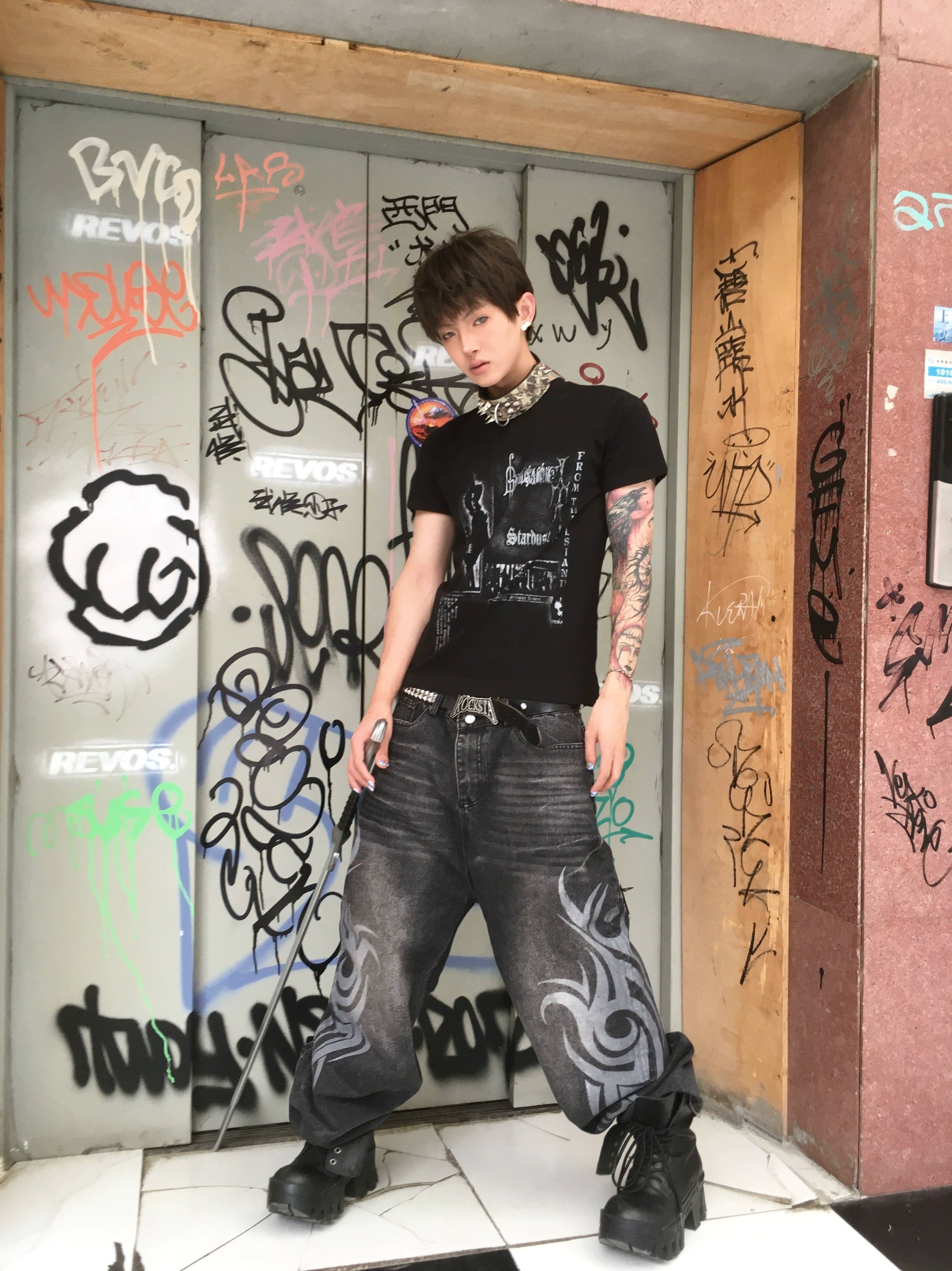 These Sanhoostudio jeans showcase bold totem rune prints across a wide-leg straight cut. The oversized fit and retro wash add cultural inspiration to streetwear, making them a unique fashion-forward piece.