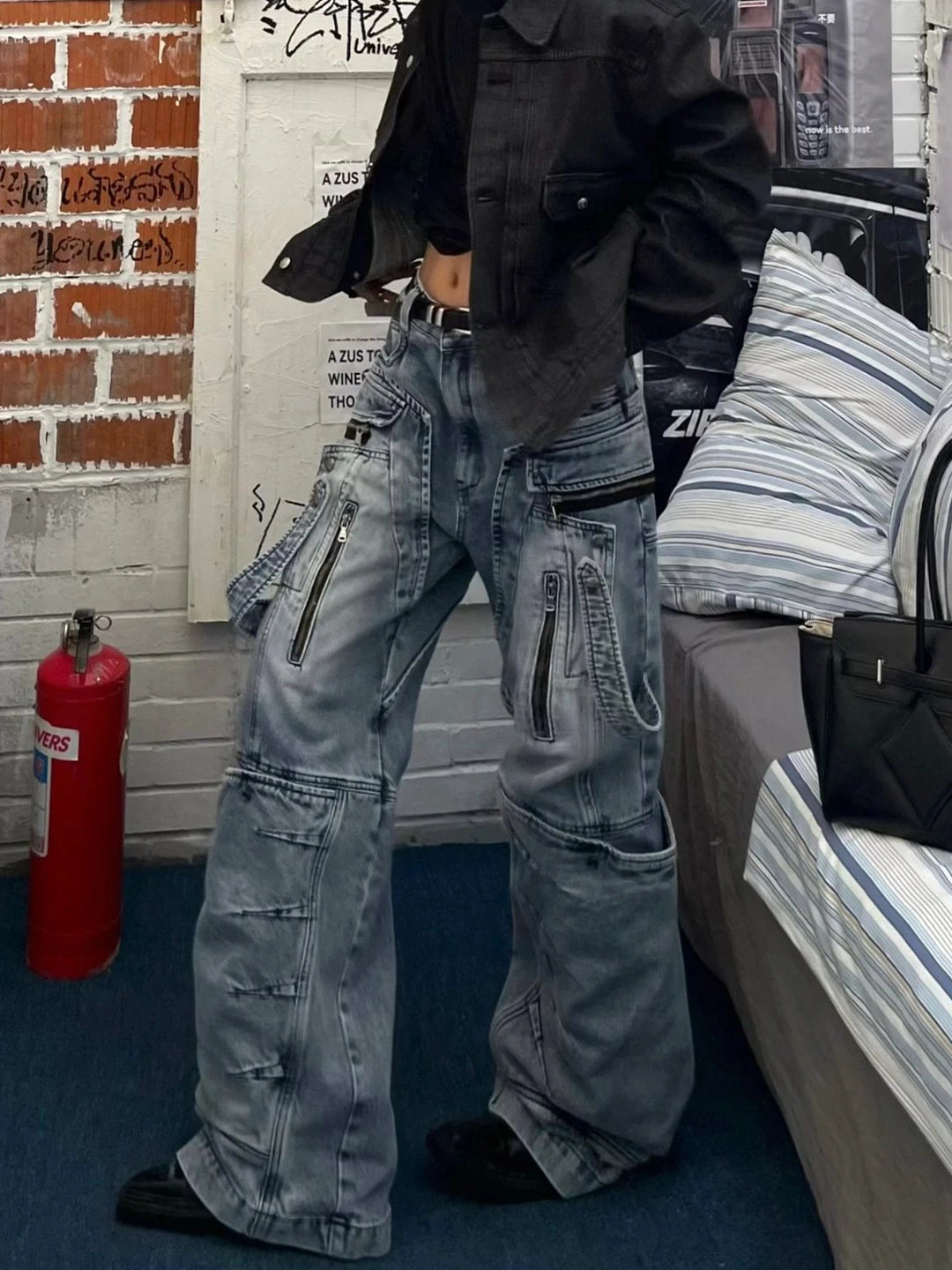 These heavy-duty cargo pants from Sanhoostudio combine deconstructed patchwork with multi-pocket functionality, delivering rugged streetwear style in a wide-leg floor-length cut. A bold fashion-forward piece.