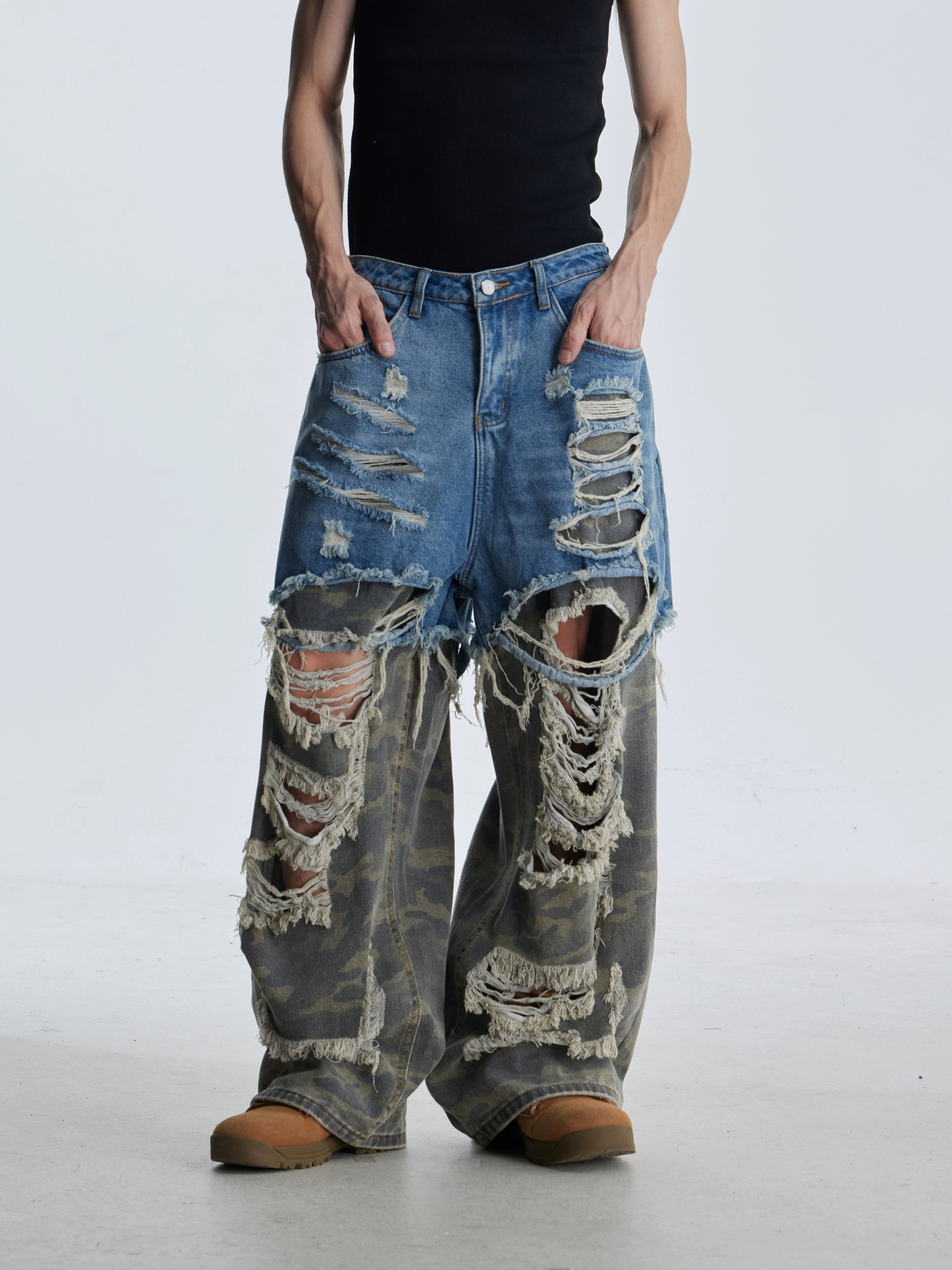 These deconstructed patchwork camo jeans from Sanhoostudio feature a unique layered fake two-piece effect, distressed ripped accents, and a loose straight-leg silhouette. Combining vintage inspiration with edgy high street aesthetics, they are perfect for streetwear lovers seeking comfort, individuality.