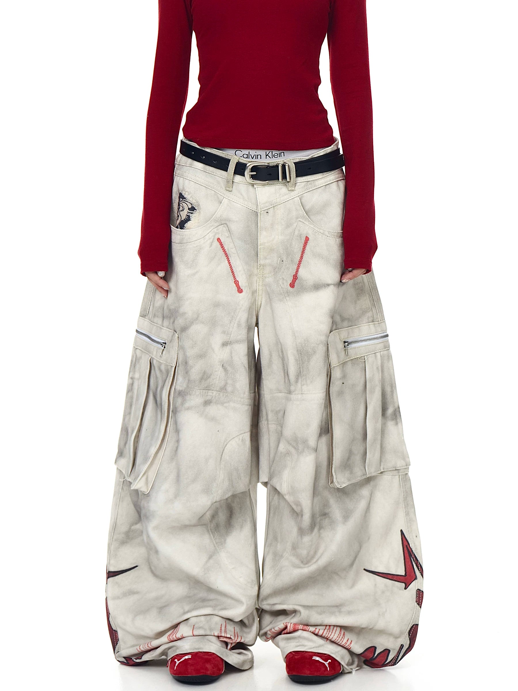 Sanhoostudio wide leg denim pants featuring distressed wash, graffiti details, and multi-pocket workwear design. Built with pleated structure for bold streetwear styling.