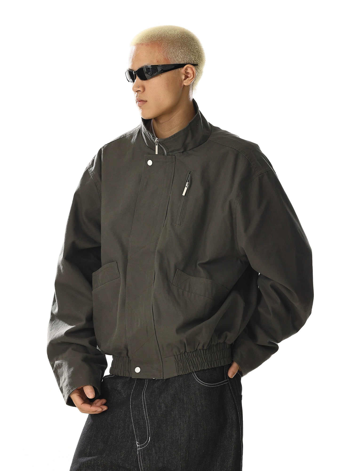 Crafted for versatility, this retro-inspired flight jacket features a stand collar and utility pocket design. Its cleanfit tailoring and oversized comfort make it a staple for streetwear enthusiasts. Shop unique outerwear at Sanhoostudio.