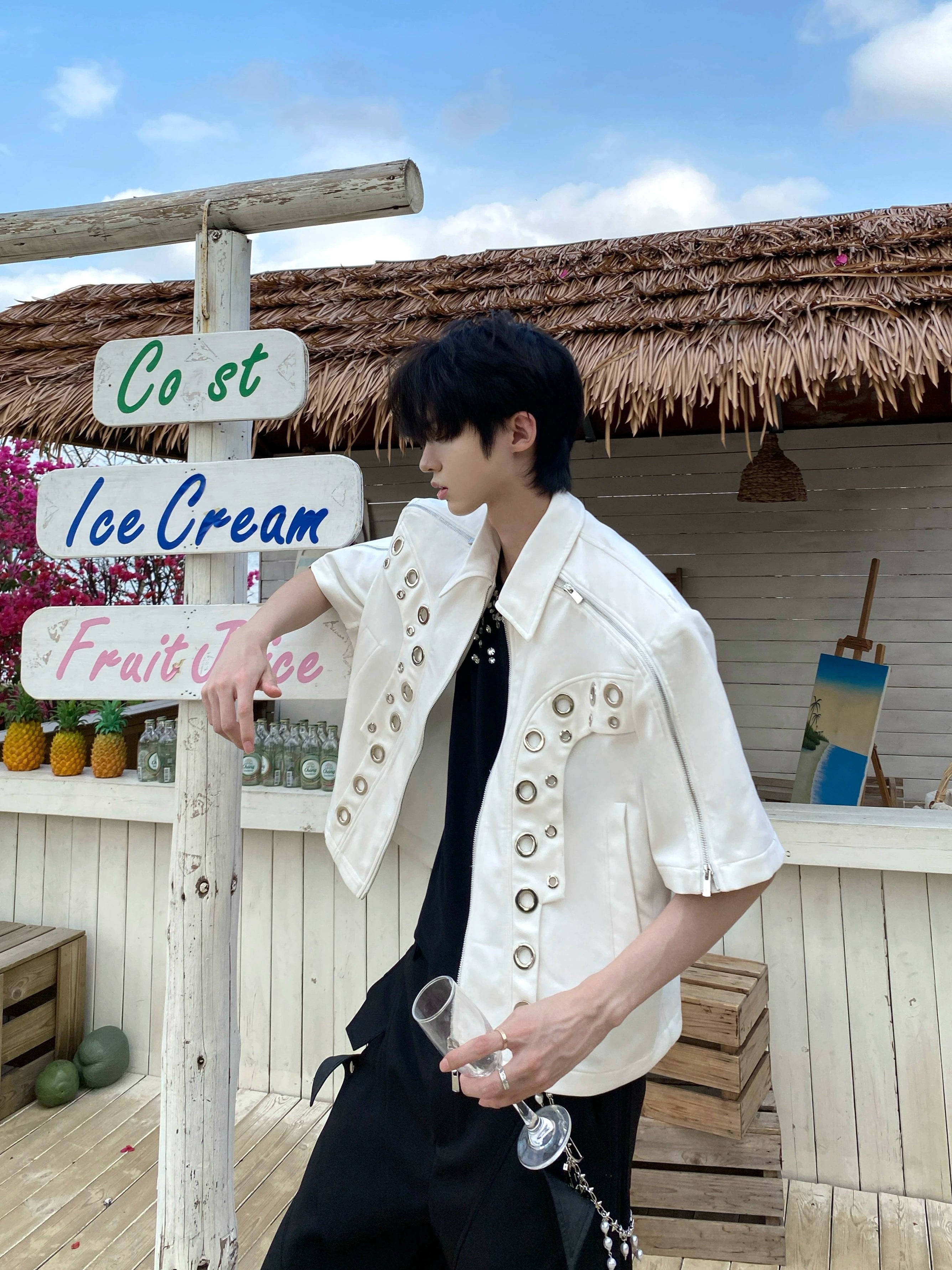 This avant-garde cropped jacket by Sanhoostudio showcases futuristic hollow-metal inspired cutouts with bold shoulder pads. Its oversized silhouette, lightweight material, and modern edge make it a standout layering piece for streetwear fans who embrace unique design and cutting-edge style.