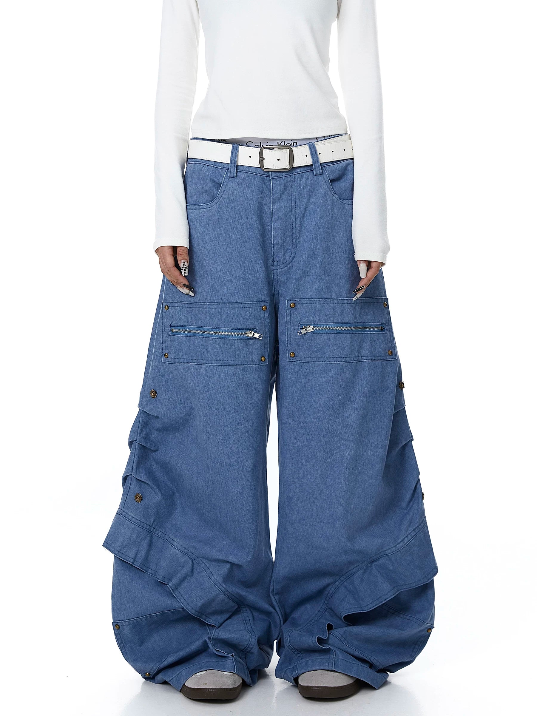 Sanhoostudio workwear denim pants featuring heavy patchwork construction and multiple utility pockets. Designed with a wide leg silhouette for modern streetwear outfits.