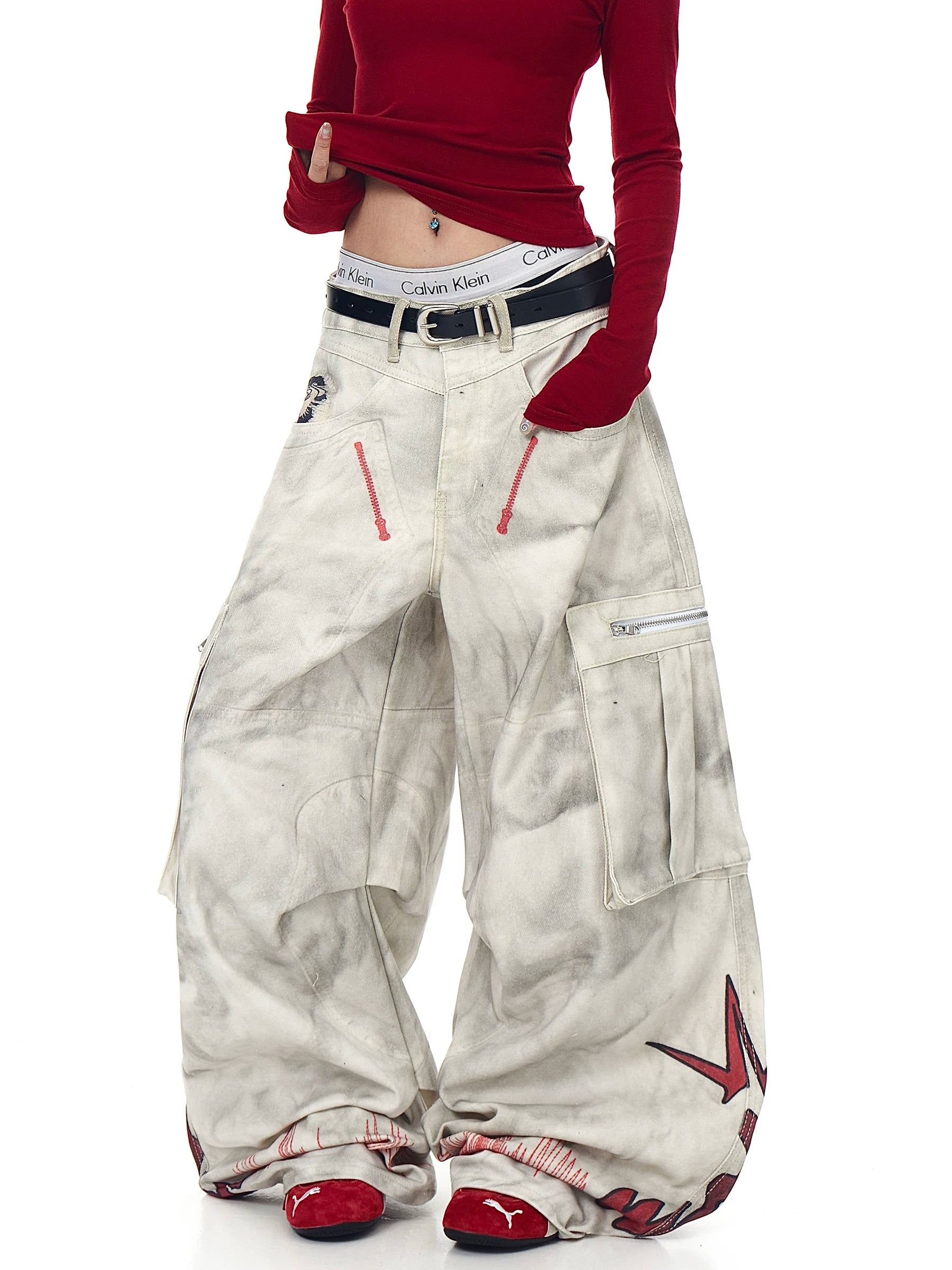 Sanhoostudio wide leg denim pants featuring distressed wash, graffiti details, and multi-pocket workwear design. Built with pleated structure for bold streetwear styling.