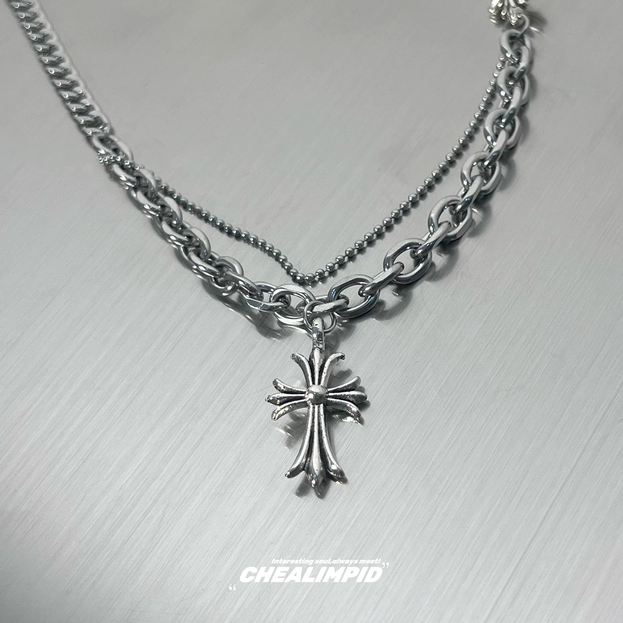 Discover Sanhoostudio’s cross double-layer titanium necklace—sturdy titanium construction paired with layered chains for a versatile unisex accessory suitable for casual and dressy street looks.