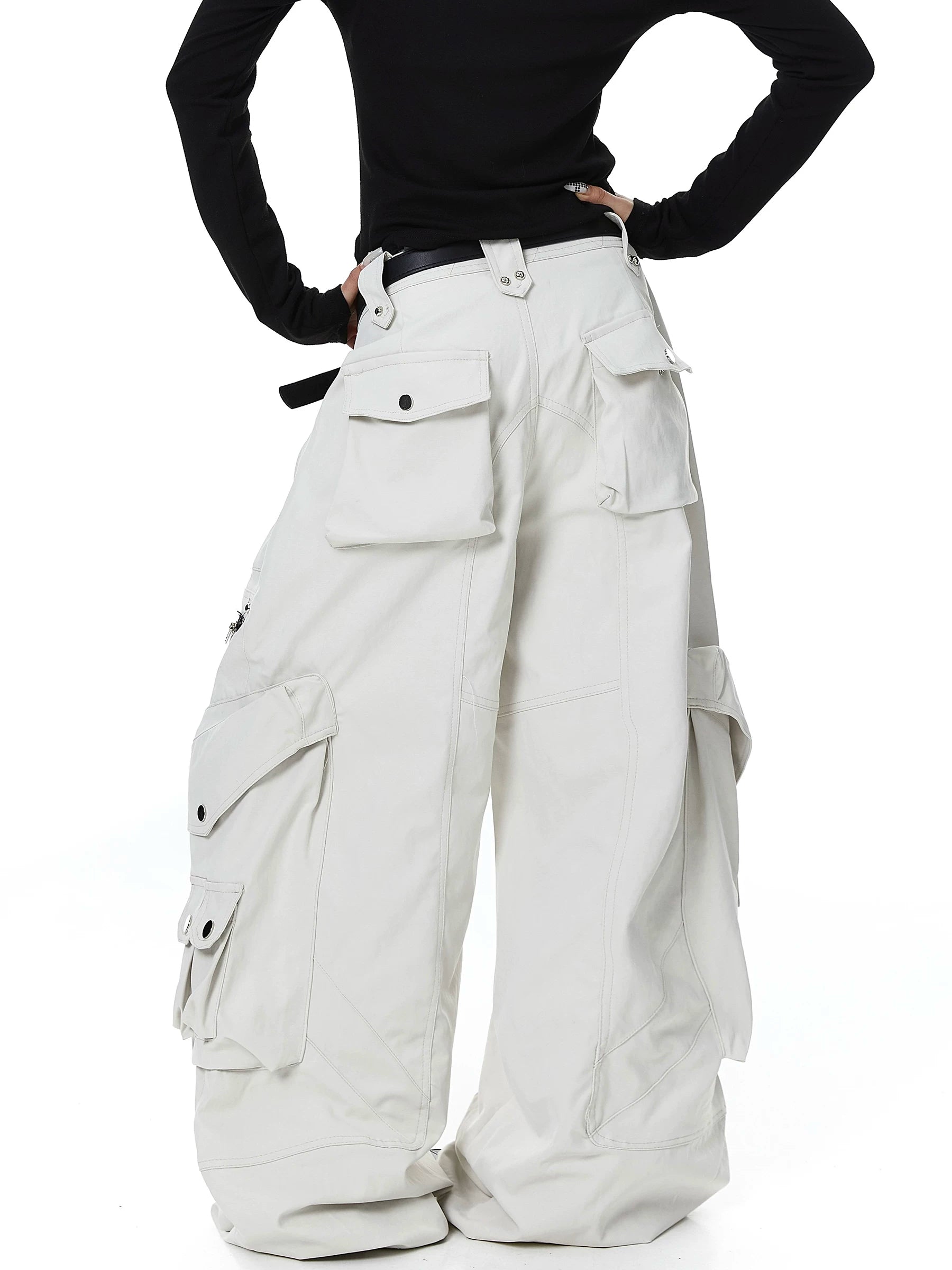 Sanhoostudio cargo pants featuring heavy utility construction, stud details, and multi-pocket design. Built with a wide leg silhouette for bold streetwear outfits.