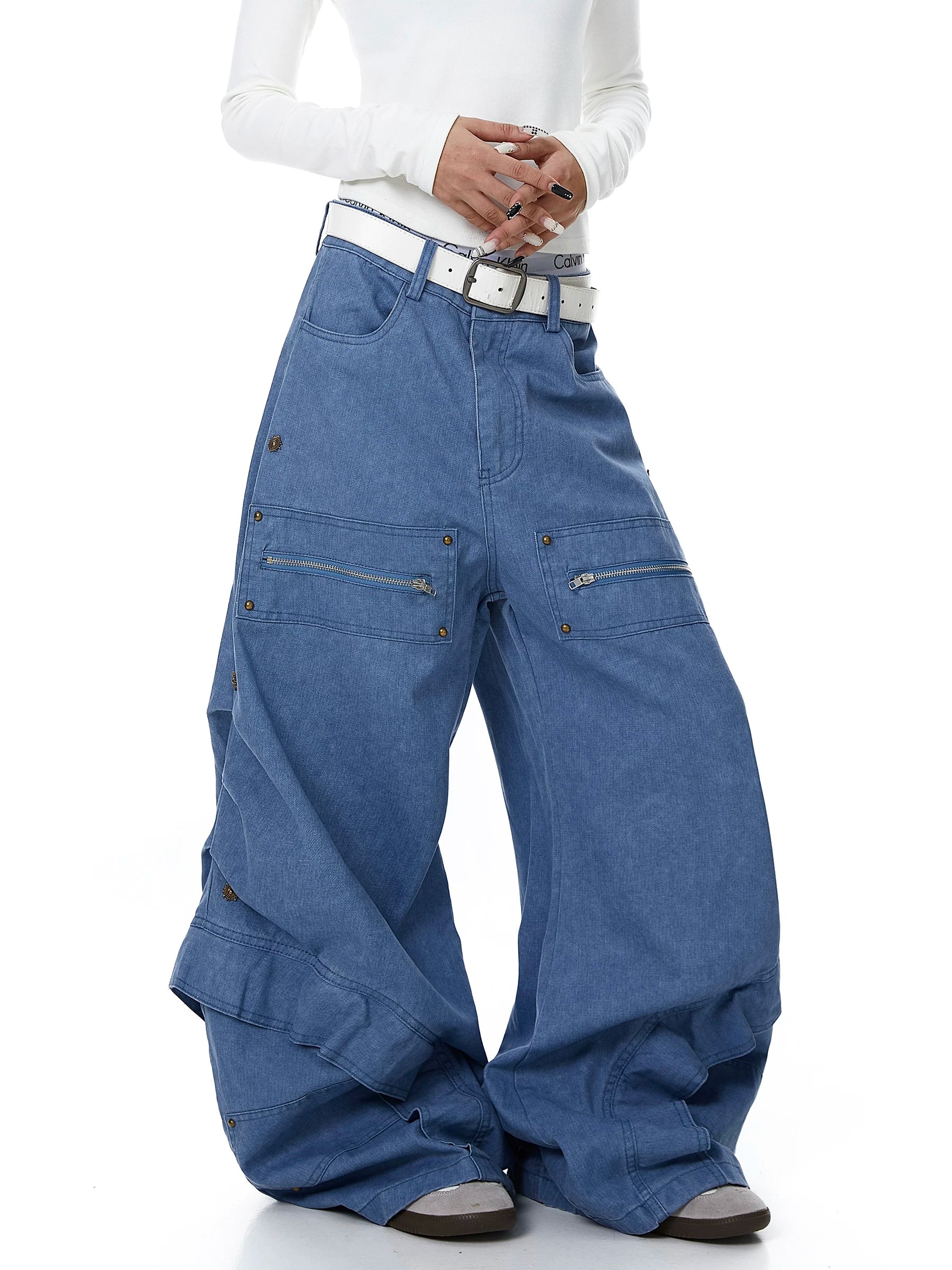 Sanhoostudio workwear denim pants featuring heavy patchwork construction and multiple utility pockets. Designed with a wide leg silhouette for modern streetwear outfits.