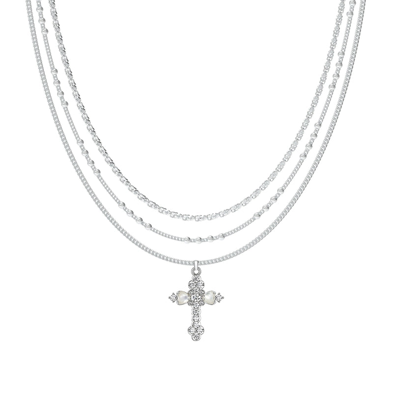 Embrace soft elegance with Sanhoostudio’s layered petal cross necklace. Adorned with mother-of-pearl accents, it brings timeless charm and modern refinement to your style.