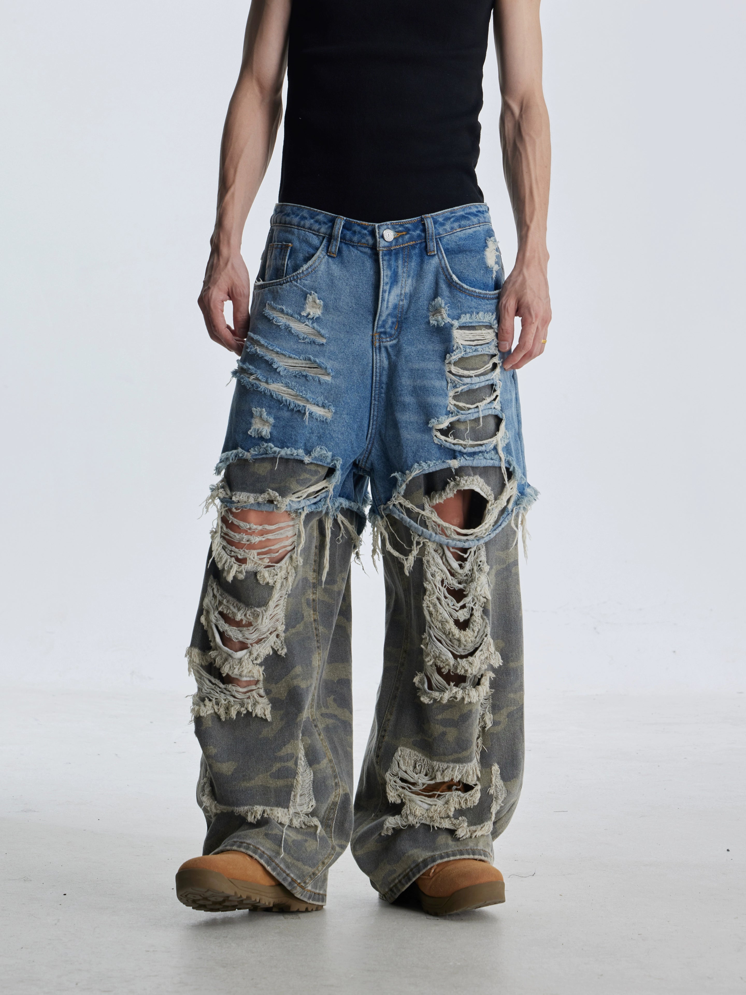 These deconstructed patchwork camo jeans from Sanhoostudio feature a unique layered fake two-piece effect, distressed ripped accents, and a loose straight-leg silhouette. Combining vintage inspiration with edgy high street aesthetics, they are perfect for streetwear lovers seeking comfort, individuality.
