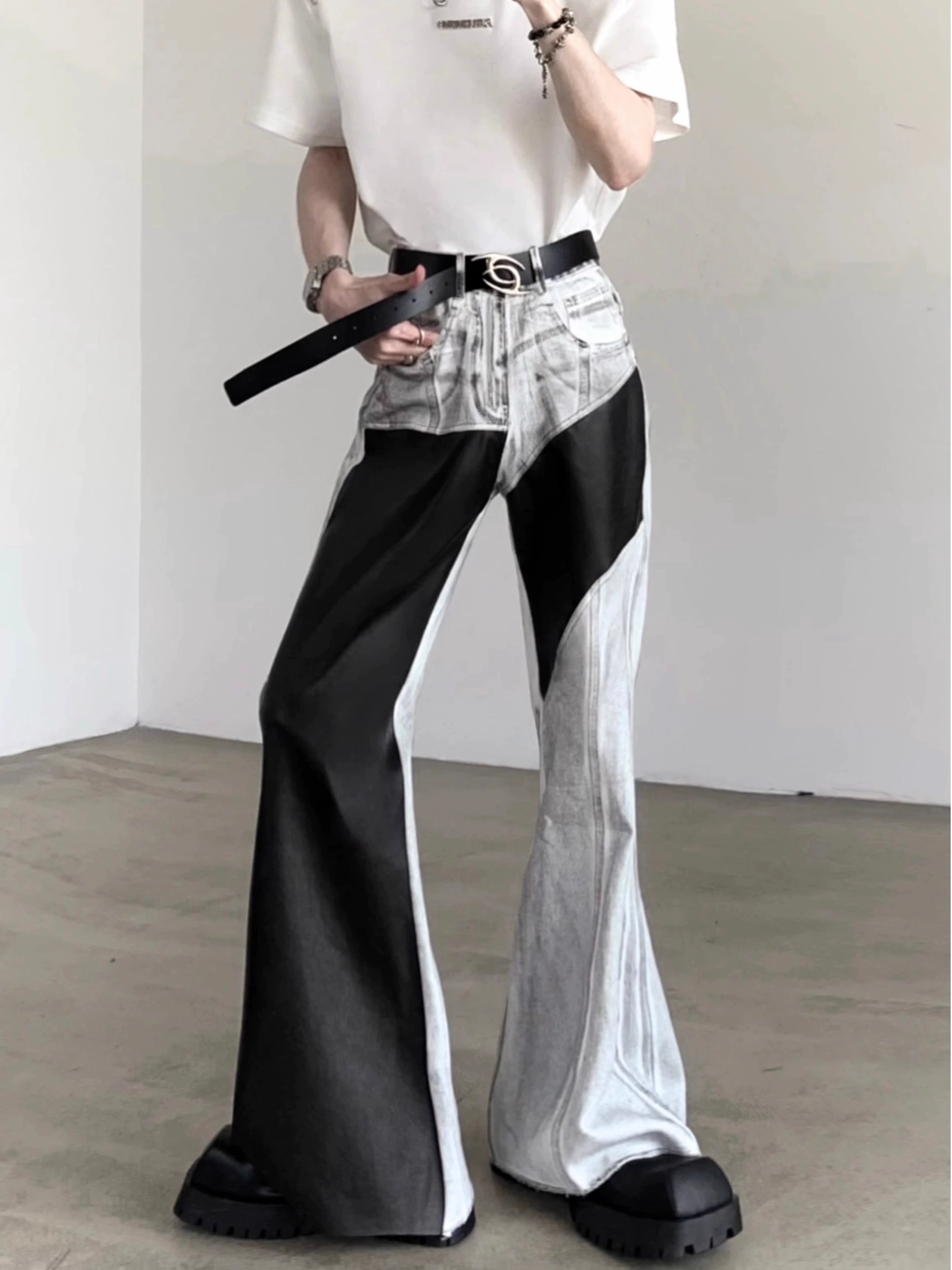 The Sanhoostudio distressed off-white jeans combine premium leather patchwork with a subtle flared cut. Their faded finish adds a rugged vintage vibe, while the unique detailing enhances versatility, making them a must-have for bold, high-fashion urban wardrobes.