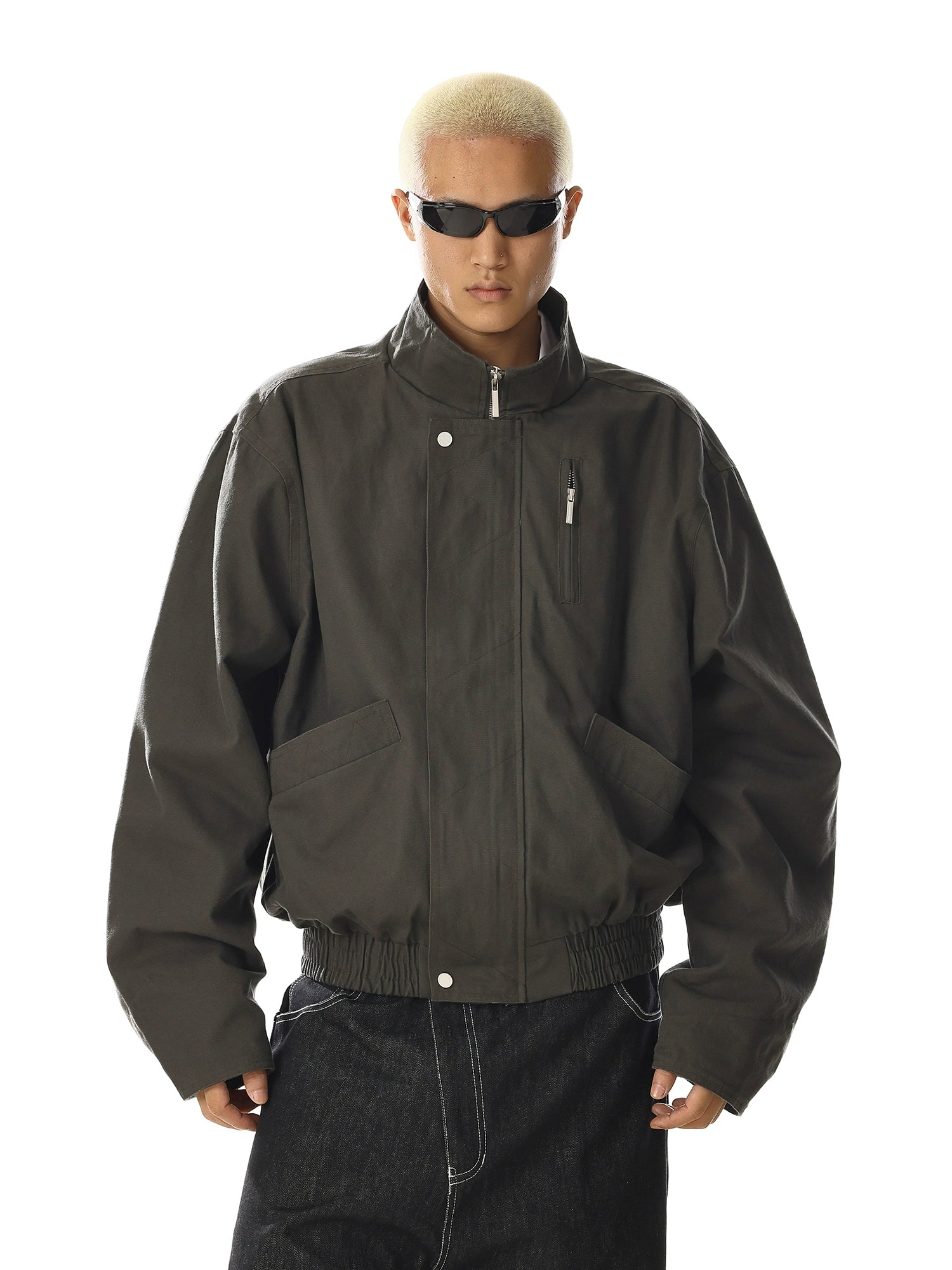 Crafted for versatility, this retro-inspired flight jacket features a stand collar and utility pocket design. Its cleanfit tailoring and oversized comfort make it a staple for streetwear enthusiasts. Shop unique outerwear at Sanhoostudio.