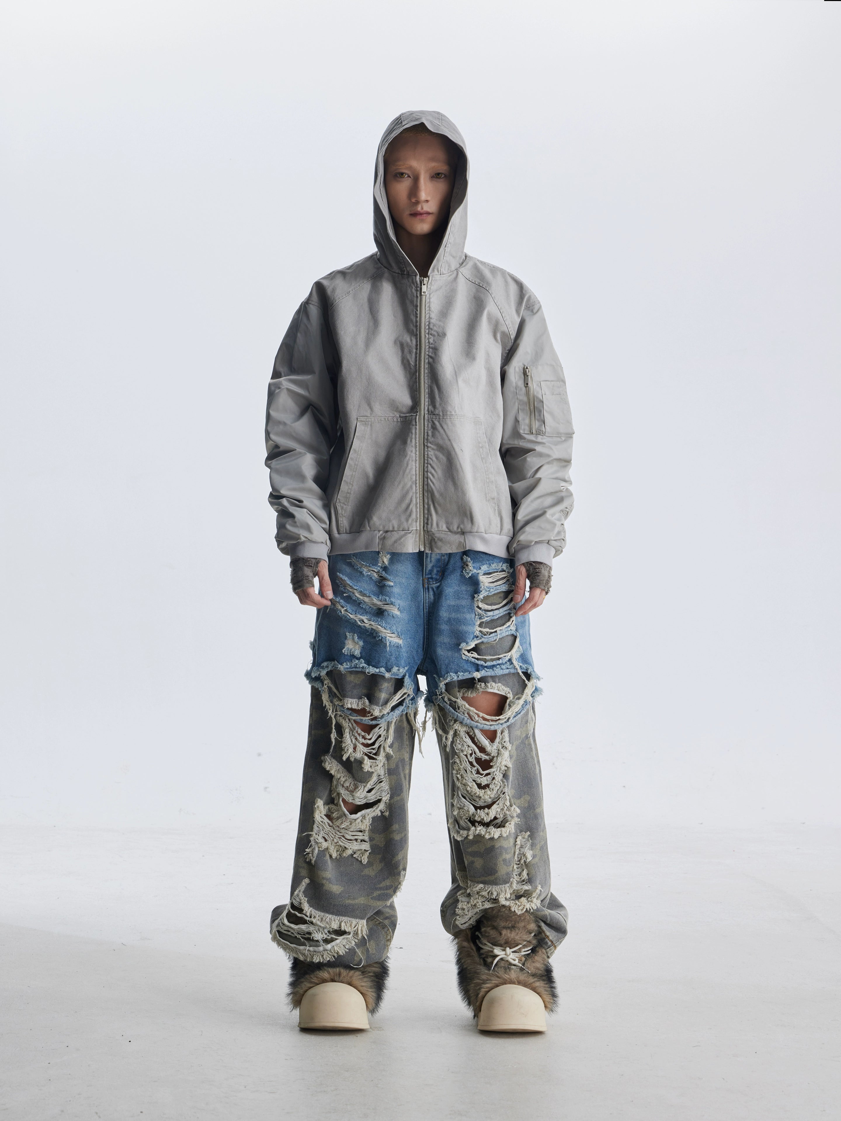 These deconstructed patchwork camo jeans from Sanhoostudio feature a unique layered fake two-piece effect, distressed ripped accents, and a loose straight-leg silhouette. Combining vintage inspiration with edgy high street aesthetics, they are perfect for streetwear lovers seeking comfort, individuality.