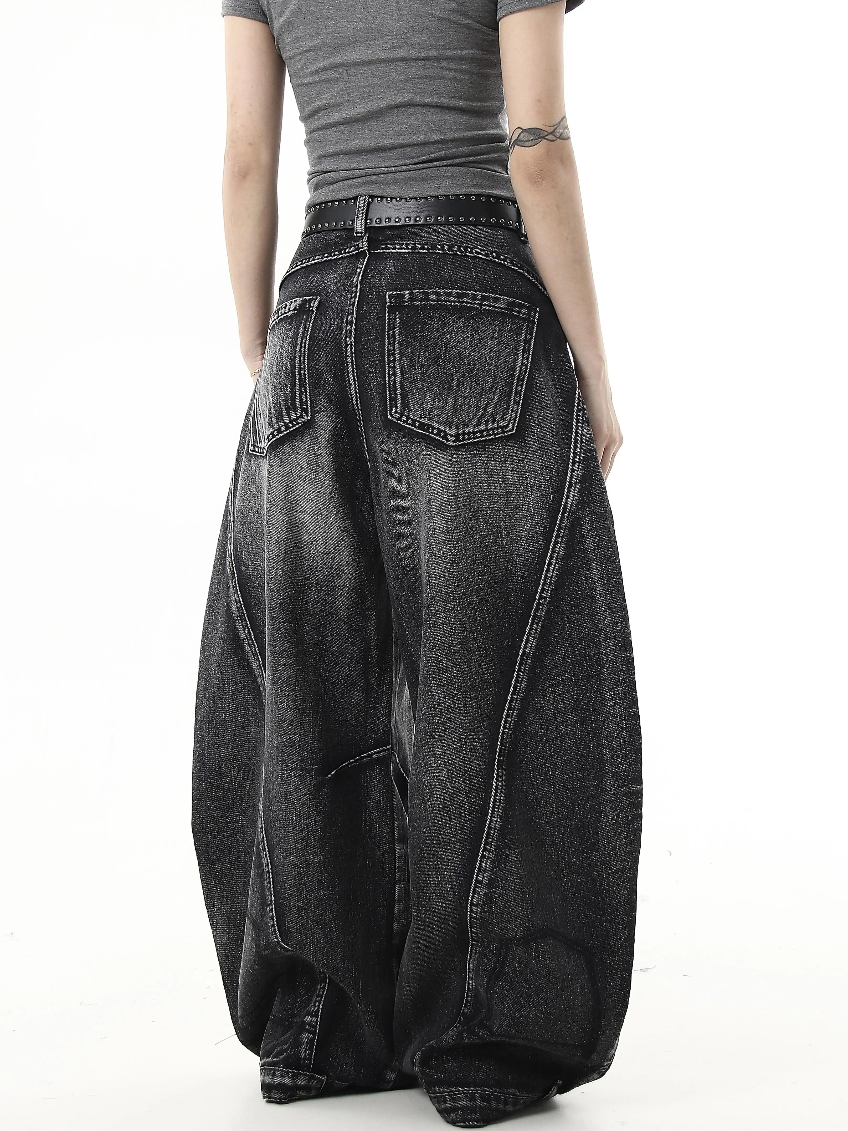 Sanhoostudio wide leg denim pants featuring washed distressing and ripped details. Designed with a curved scythe silhouette for modern high street fashion.