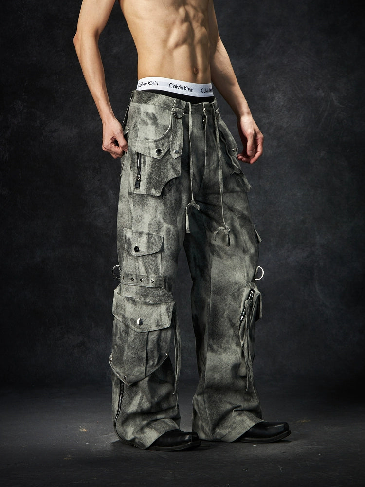 The Sanhoostudio distressed mud-dye cargo pants feature a heavy washed finish, rugged multi-pocket design, and a relaxed straight-leg fit. Perfect for utilitarian and high street styling, they combine functionality with bold design, making them an essential statement for everyday streetwear wardrobes.