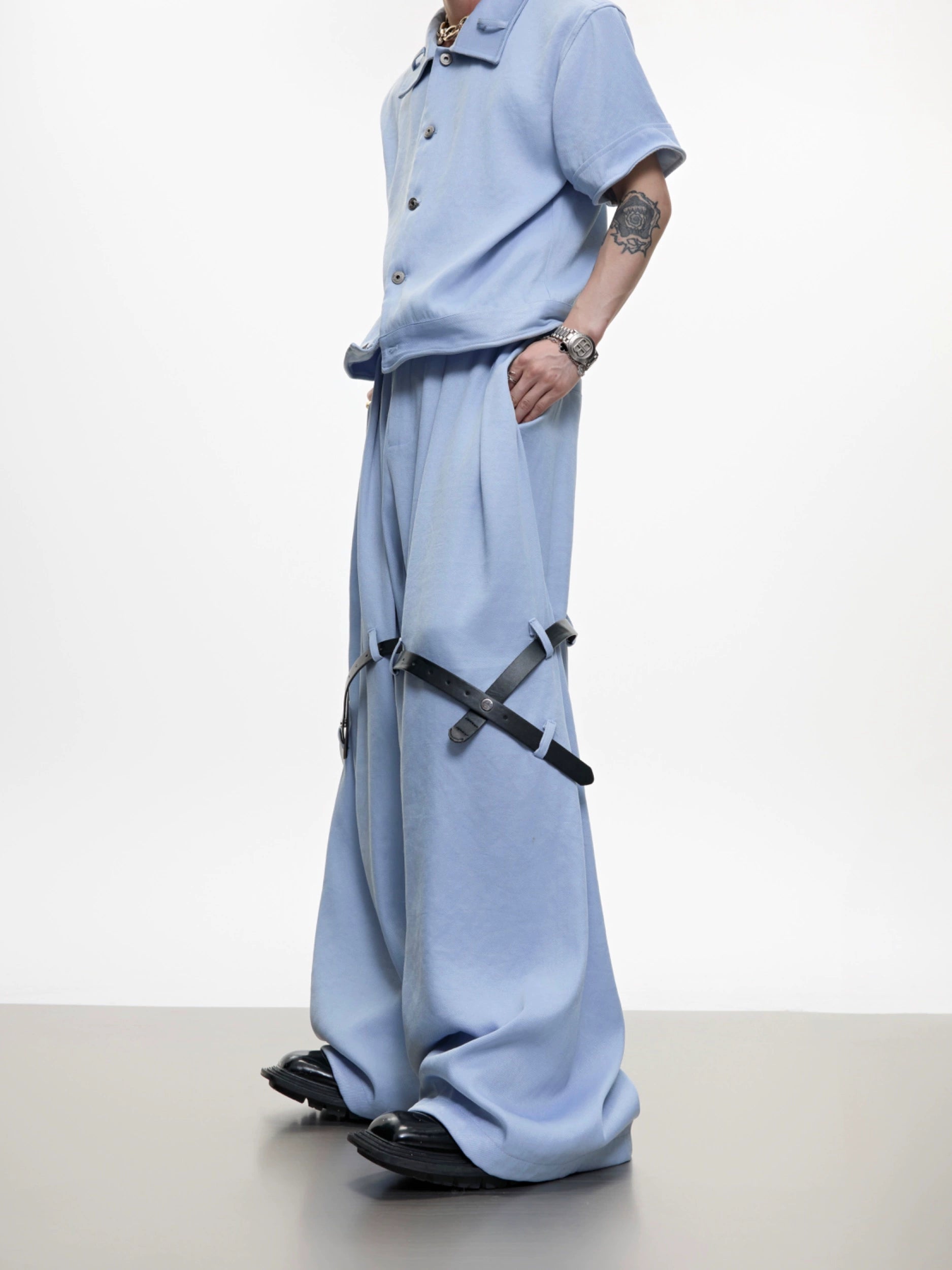 The Sanhoostudio twill textured pants showcase structured tailoring with unique belt-inspired patchwork. Combining minimalism with avant-garde detailing, they bring an elevated urban aesthetic to both casual and semi-formal styling.