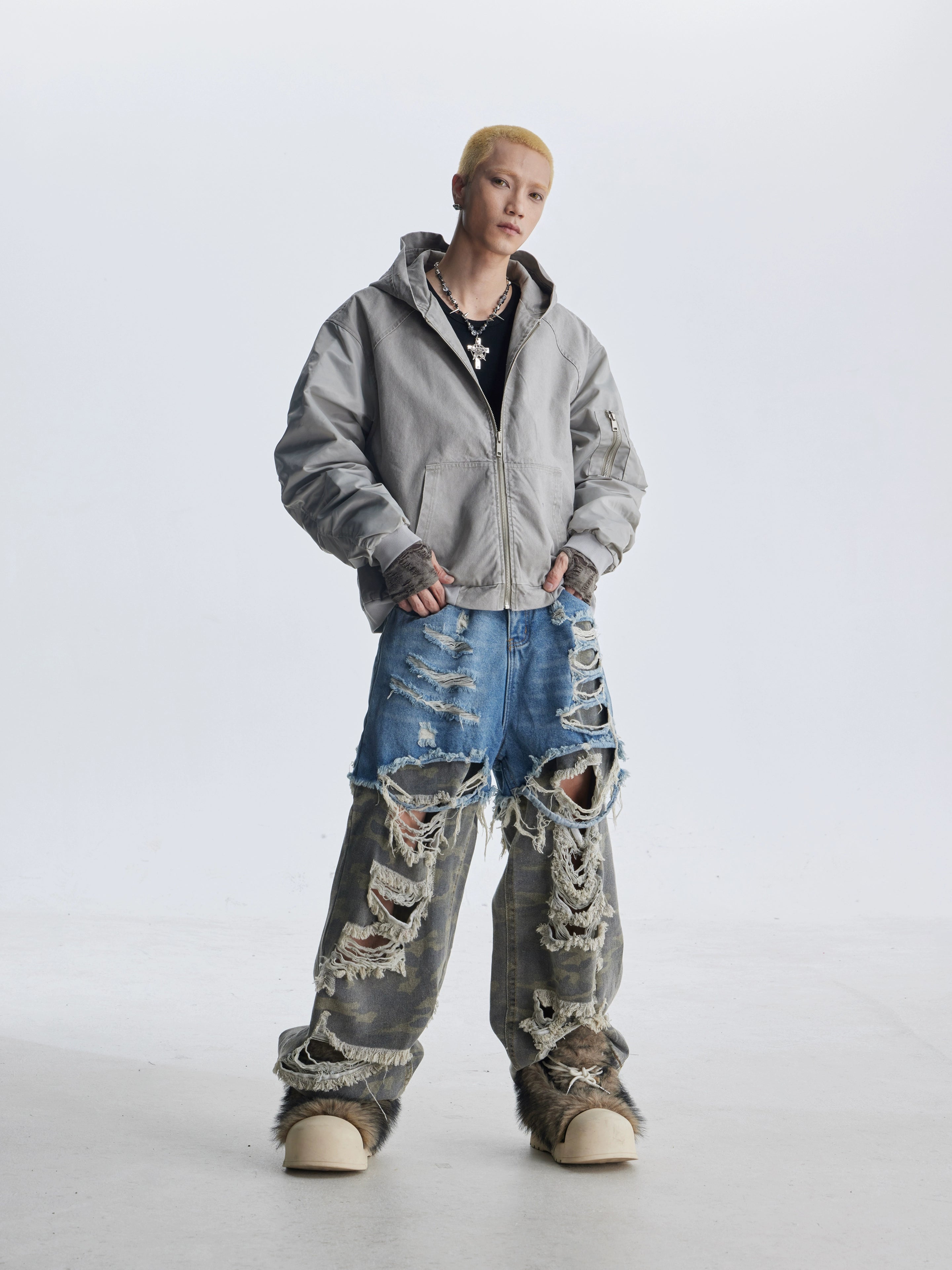 These deconstructed patchwork camo jeans from Sanhoostudio feature a unique layered fake two-piece effect, distressed ripped accents, and a loose straight-leg silhouette. Combining vintage inspiration with edgy high street aesthetics, they are perfect for streetwear lovers seeking comfort, individuality.