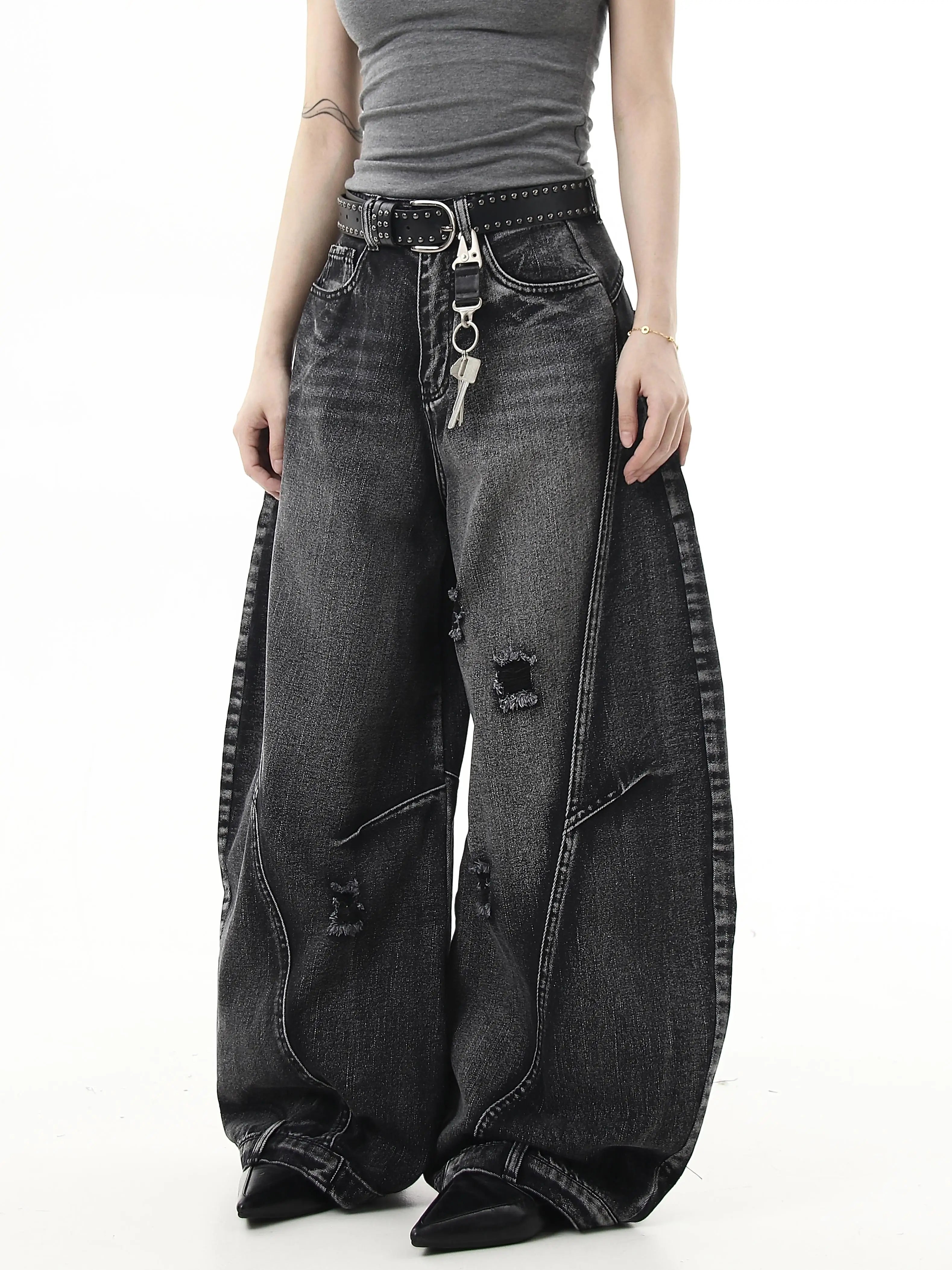 Sanhoostudio wide leg denim pants featuring washed distressing and ripped details. Designed with a curved scythe silhouette for modern high street fashion.