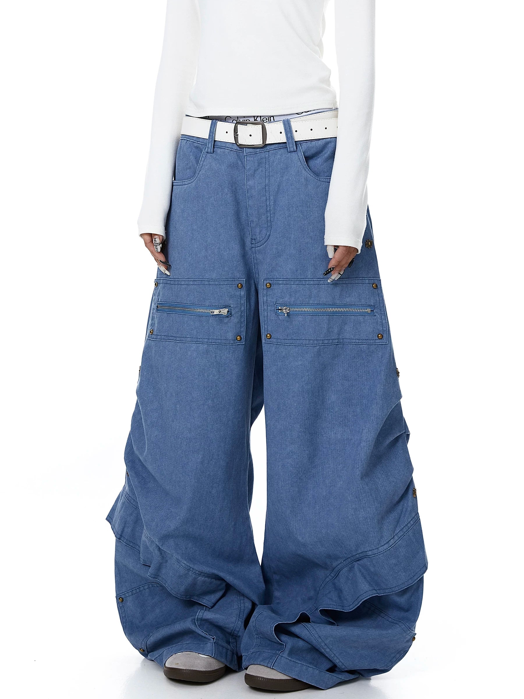 Sanhoostudio workwear denim pants featuring heavy patchwork construction and multiple utility pockets. Designed with a wide leg silhouette for modern streetwear outfits.