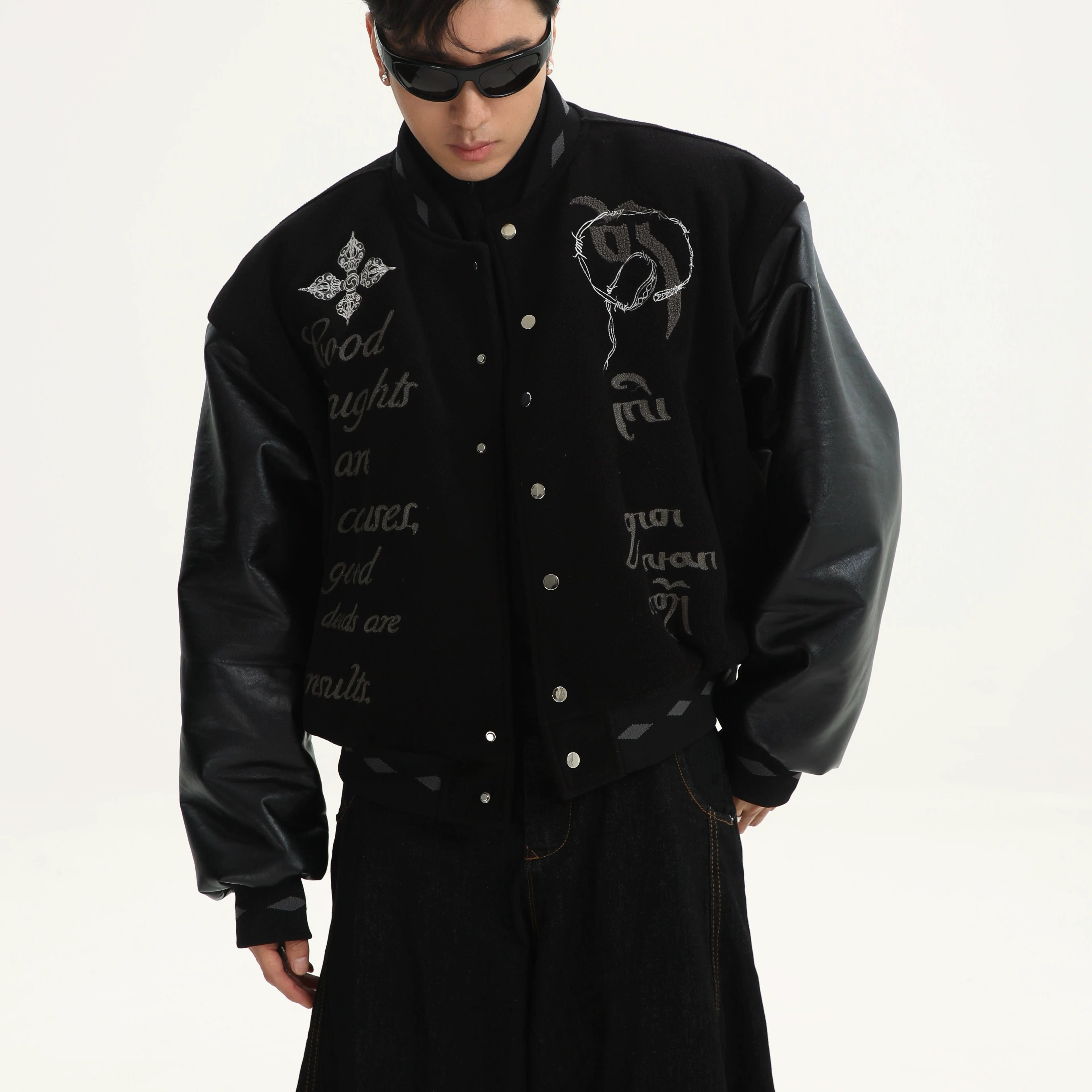 Sanhoostudio varsity jacket from the Dojie Unbound series, featuring Tibetan-inspired embroidery and heavyweight construction.