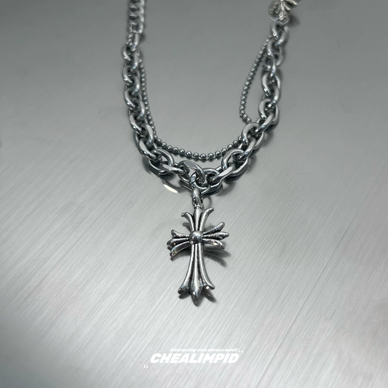 Discover Sanhoostudio’s cross double-layer titanium necklace—sturdy titanium construction paired with layered chains for a versatile unisex accessory suitable for casual and dressy street looks.