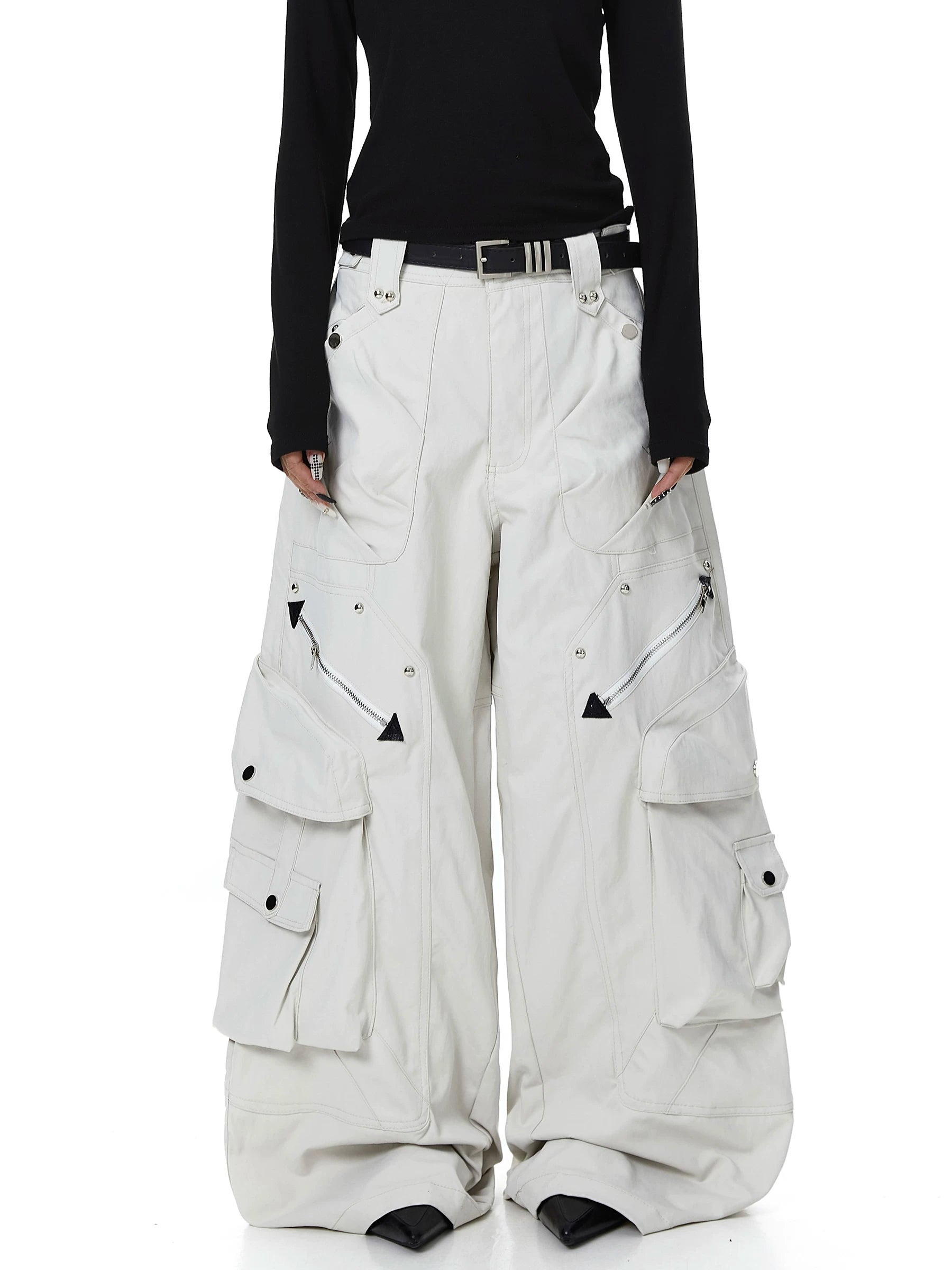 Sanhoostudio cargo pants featuring heavy utility construction, stud details, and multi-pocket design. Built with a wide leg silhouette for bold streetwear outfits.